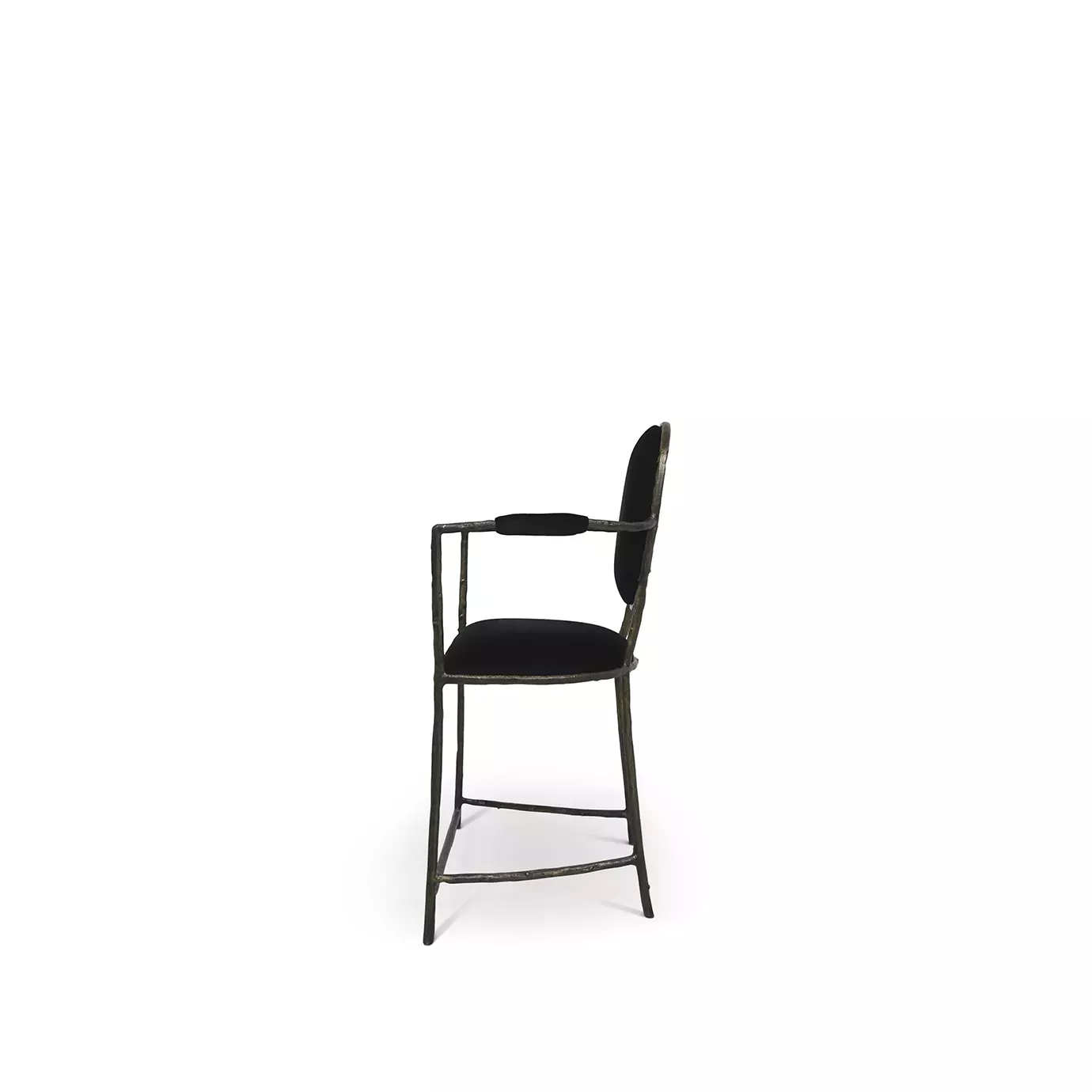Side view of the Enchanted Counter Stool, showcasing its aged brass frame resembling branches, combining with the luxurious black upholstery.