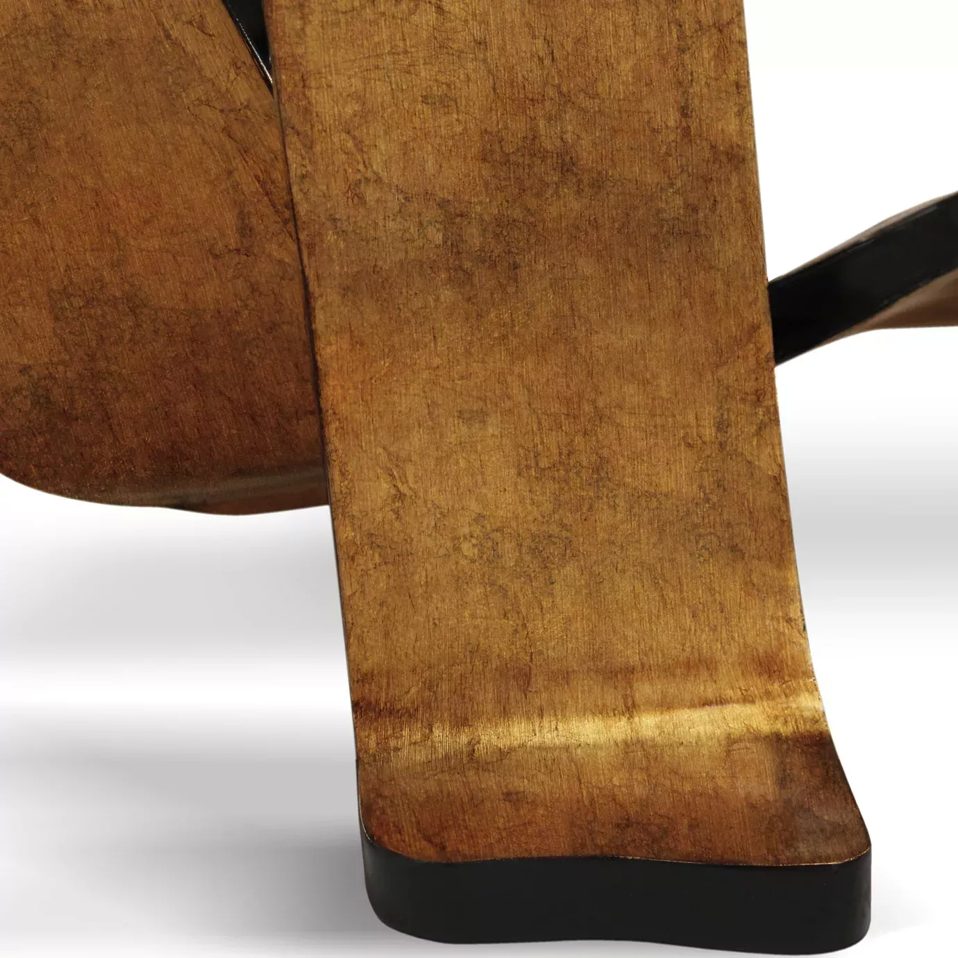Tight shot of the Ribbon Broken Copper Leaf Dining Table's base, highlighting the rich texture of the copper leaf and dark accents.