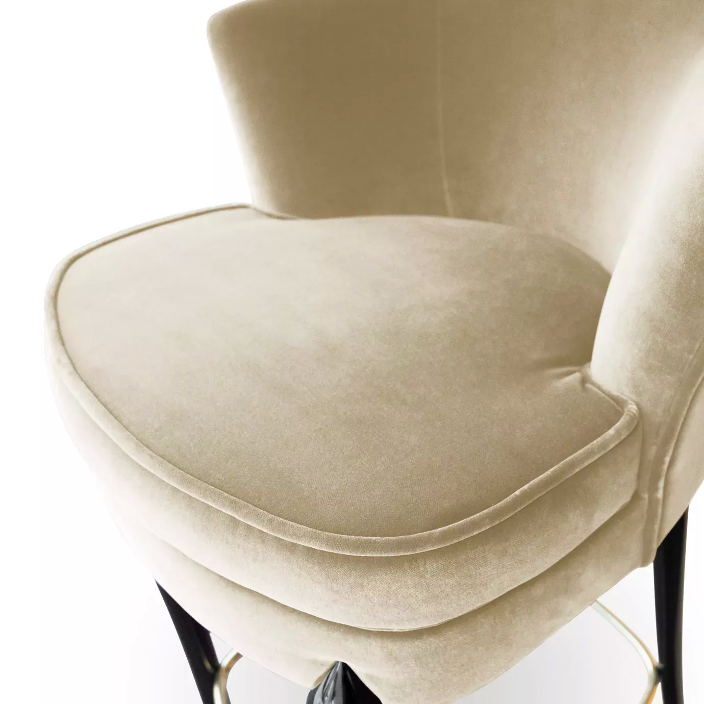 Extreme close-up of the Délice Counter Stool's plush, light beige velvet seat and the curve of its back.