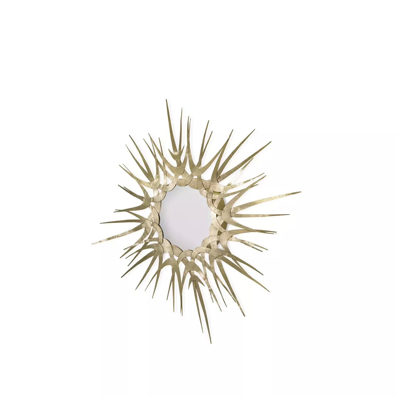 Guilt II Mirror with a striking sunburst design in gold, slightly angled and showcased in a stylish living room.