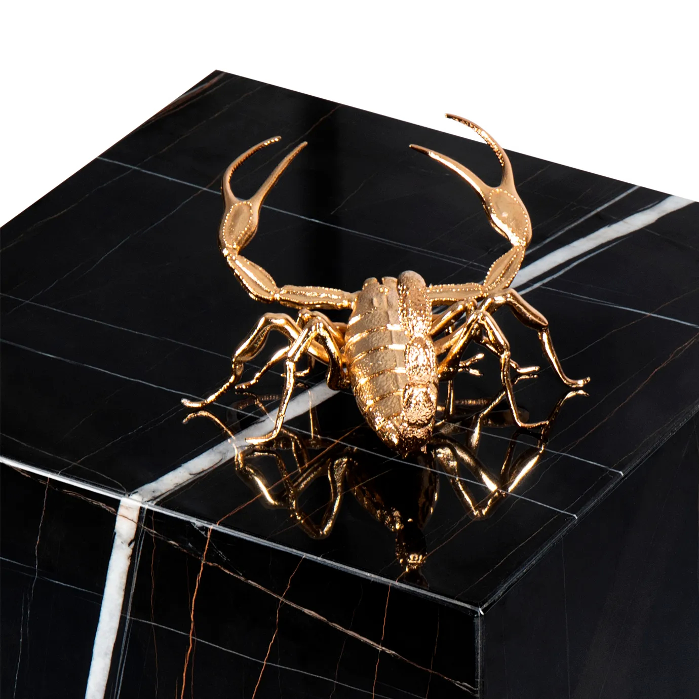 Close-up of gold scorpion sculpture on Metamorphosis Side Table, with intricate details on black marble base.