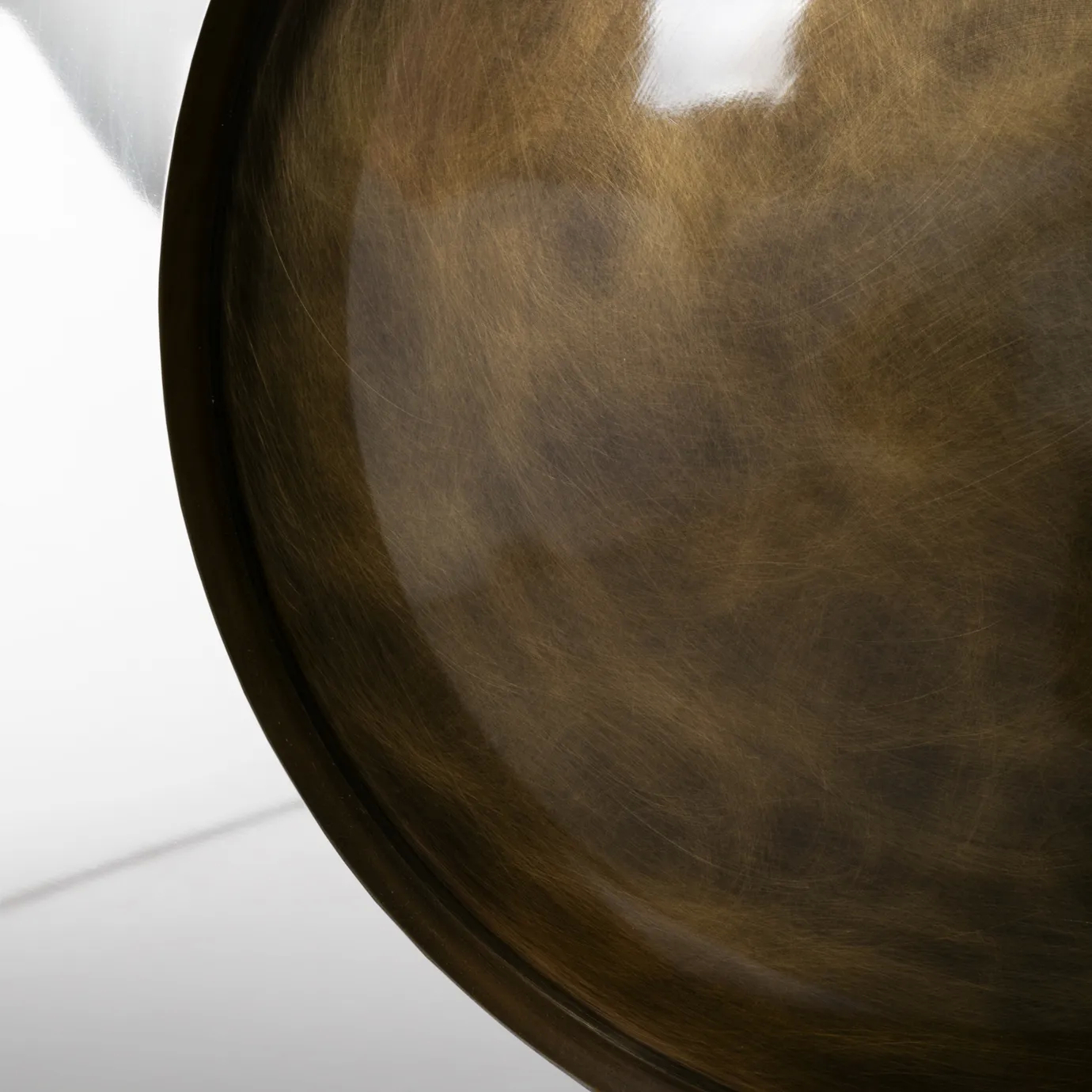 Close-up of Metamorphosis Console, showcasing the polished, reflective surface of its circular base.
