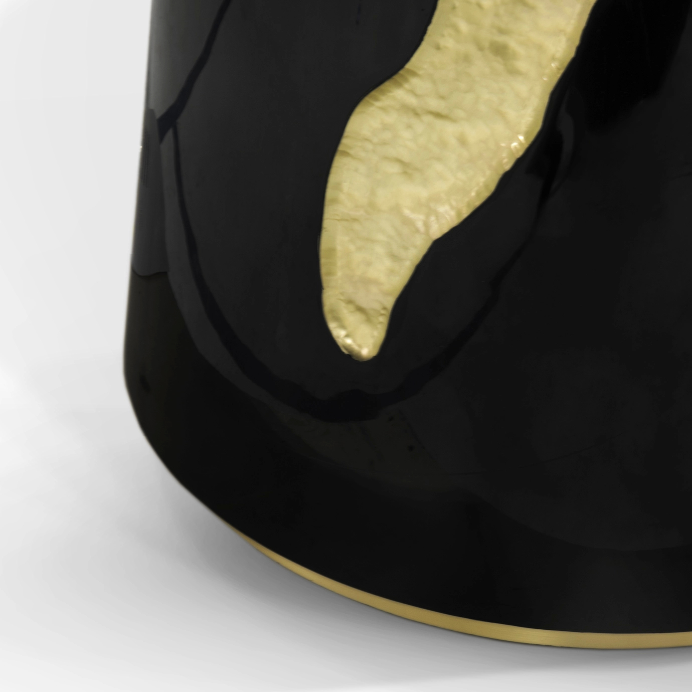 Luxurious Lapiaz Black Dining Table with golden accents on a cracked, black surface.
