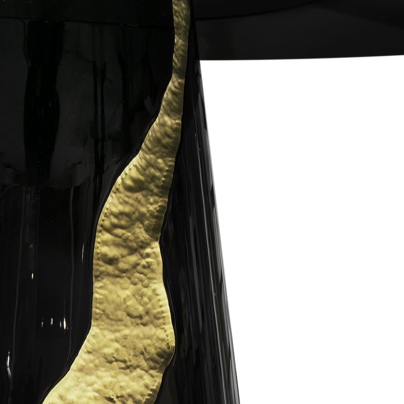 Luxurious Lapiaz Black Dining Table detail with textured gold accents.