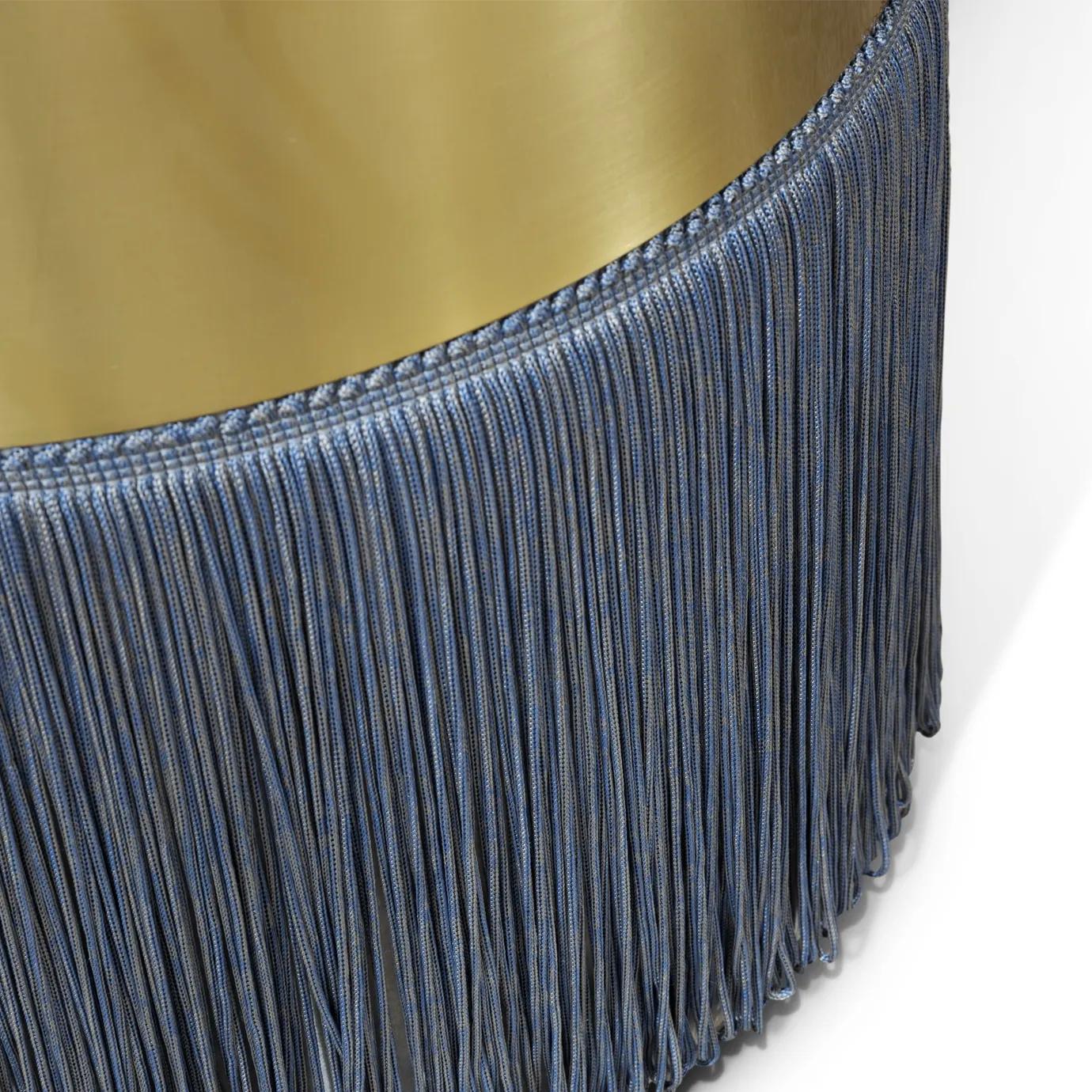 Close-up of Olivia Fabric Stool base, showcasing intricate blue fringe details against a gold band.