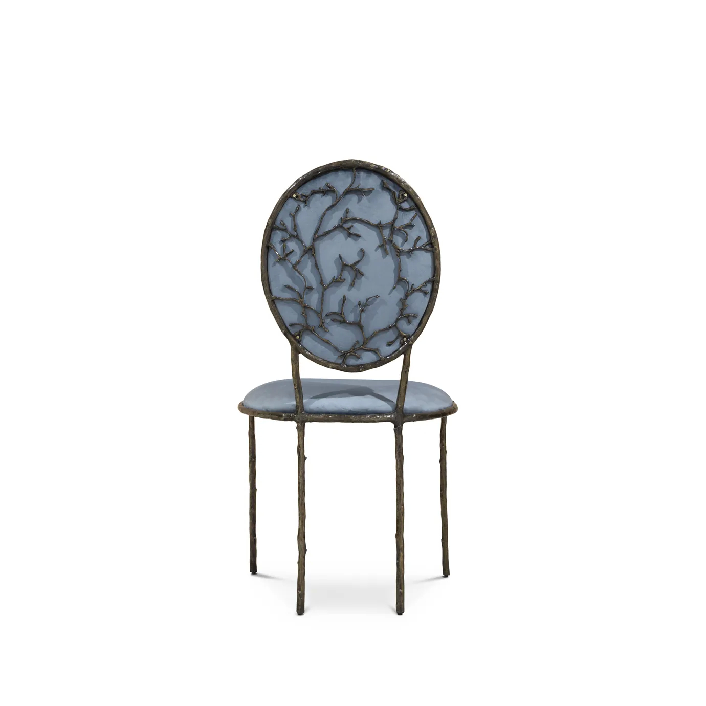 Featuring an elegant backrest resembling branches, the Enchanted Dining Chair has a luxurious blue upholstery.