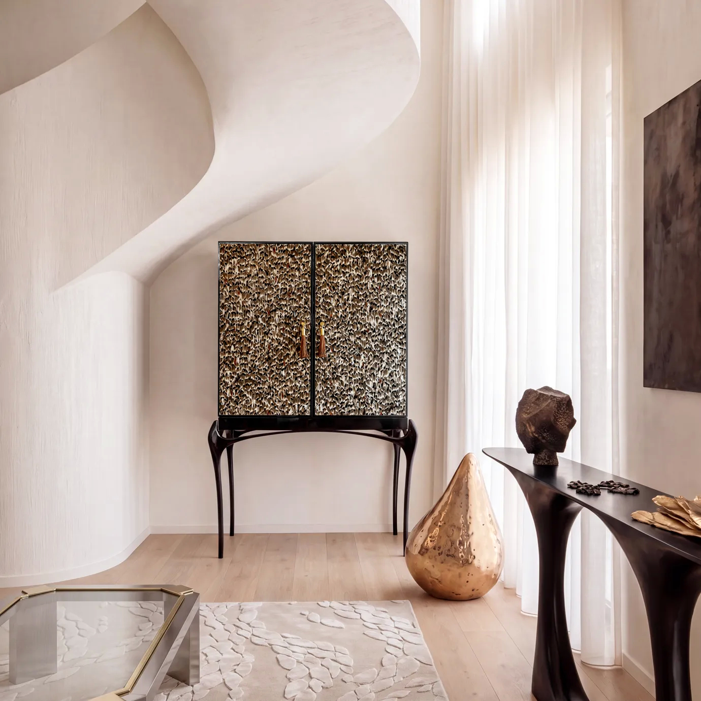 Temptation bar cabinet by KOKET in a sculptural plaster interior, Folie Feathers doors and sculptural black lacquer legs.