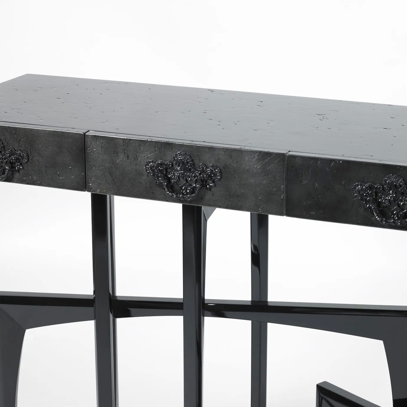 Close-up of the black console featuring sharp lines and elegant gold accents.