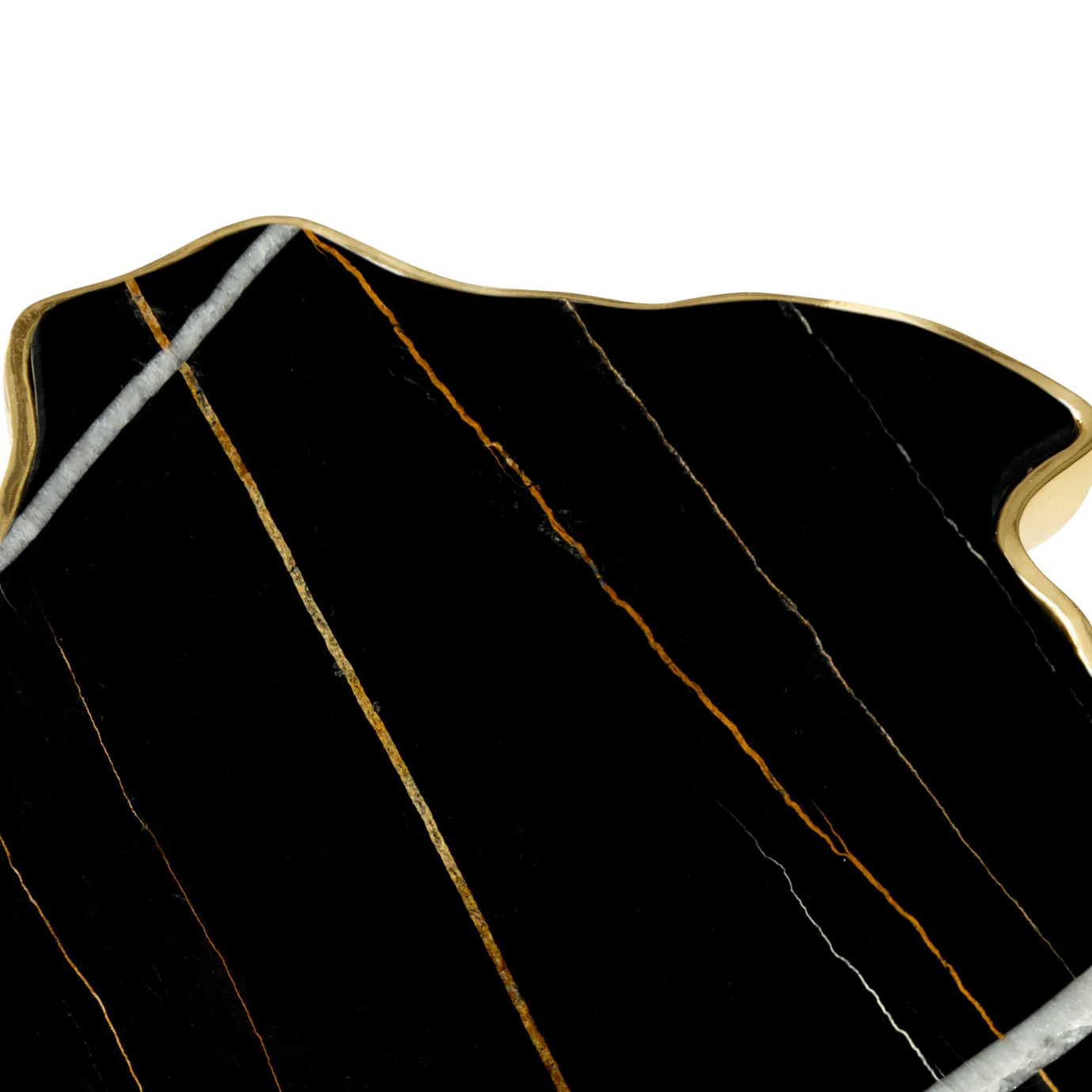 Side view highlighting the dark marble top and the intricate, nature-inspired gold base.