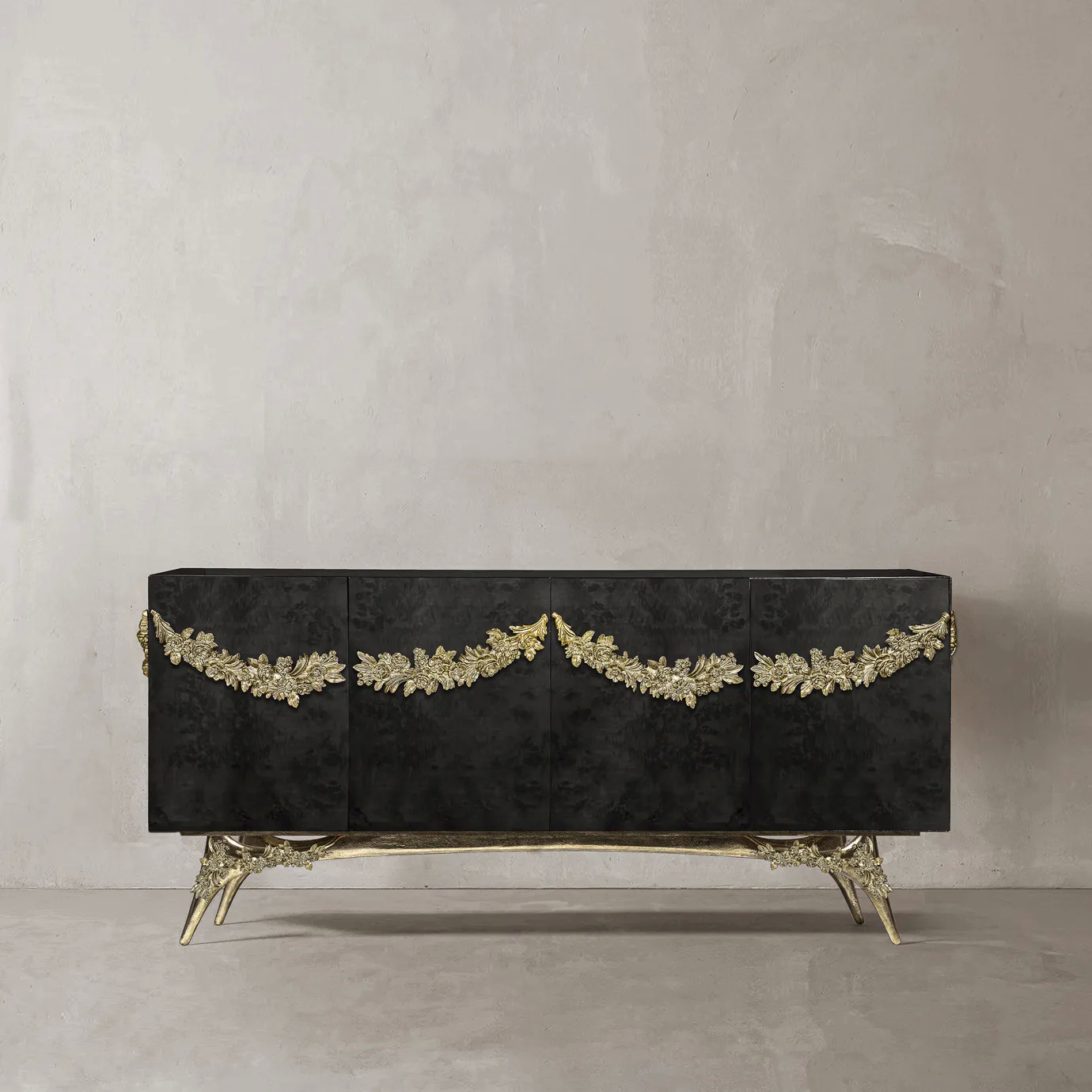 Majestic sideboard with black walnut veneer, gold garland, and sculptural brass base.