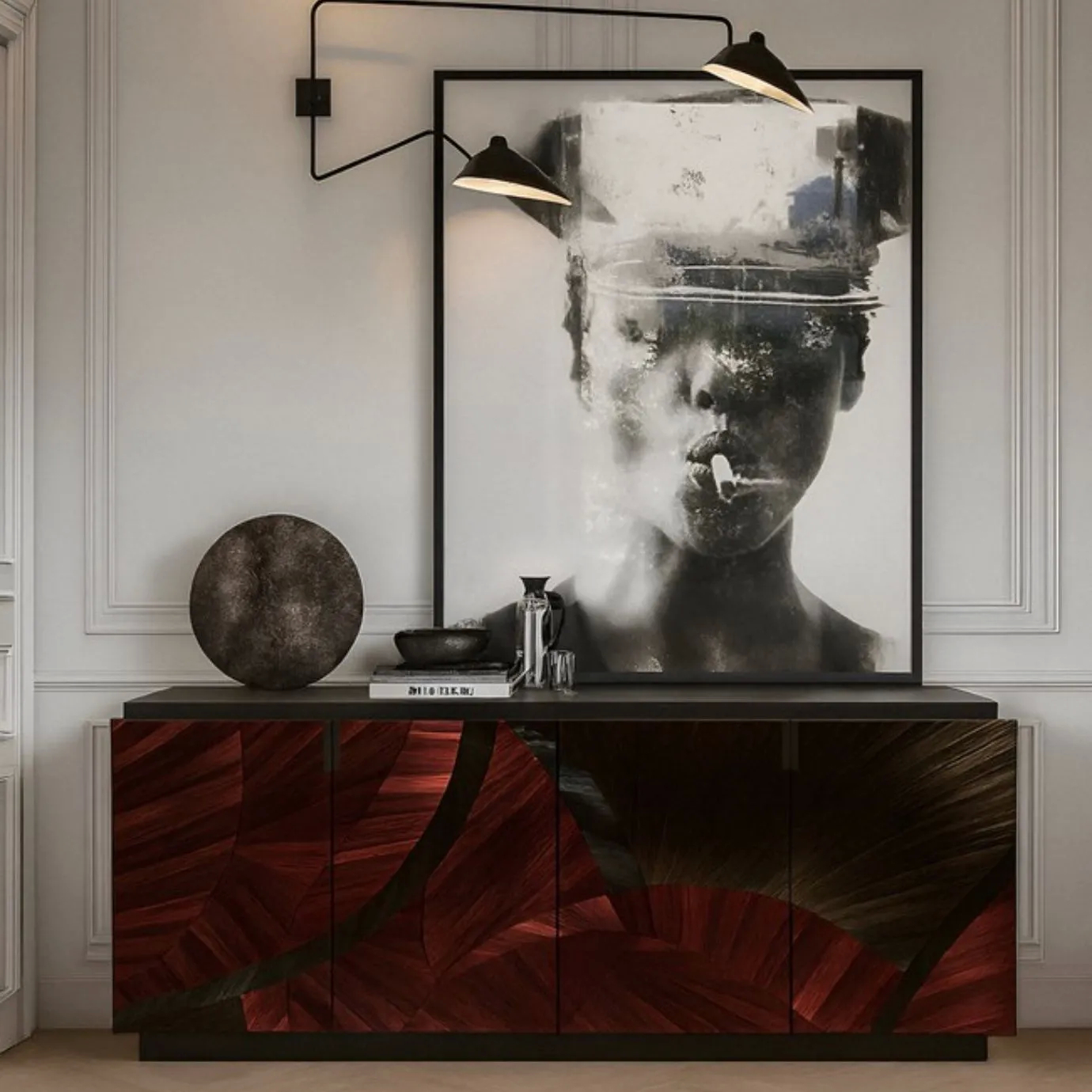 Sahara Cabinet with glossy red and dark brown abstract finish, styled with a round textured sculpture, coffee set, and large black-and-white portrait artwork, flanked by black wall sconces with gold interiors in a modern interior with white molding.