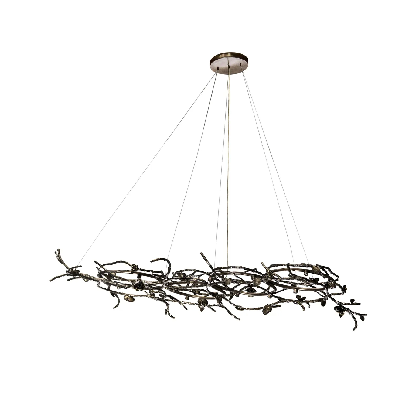 Rose Chandelier in aged brass with sculptural vine-like branches and delicate bud details, suspended by thin cables in a modern interior setting.