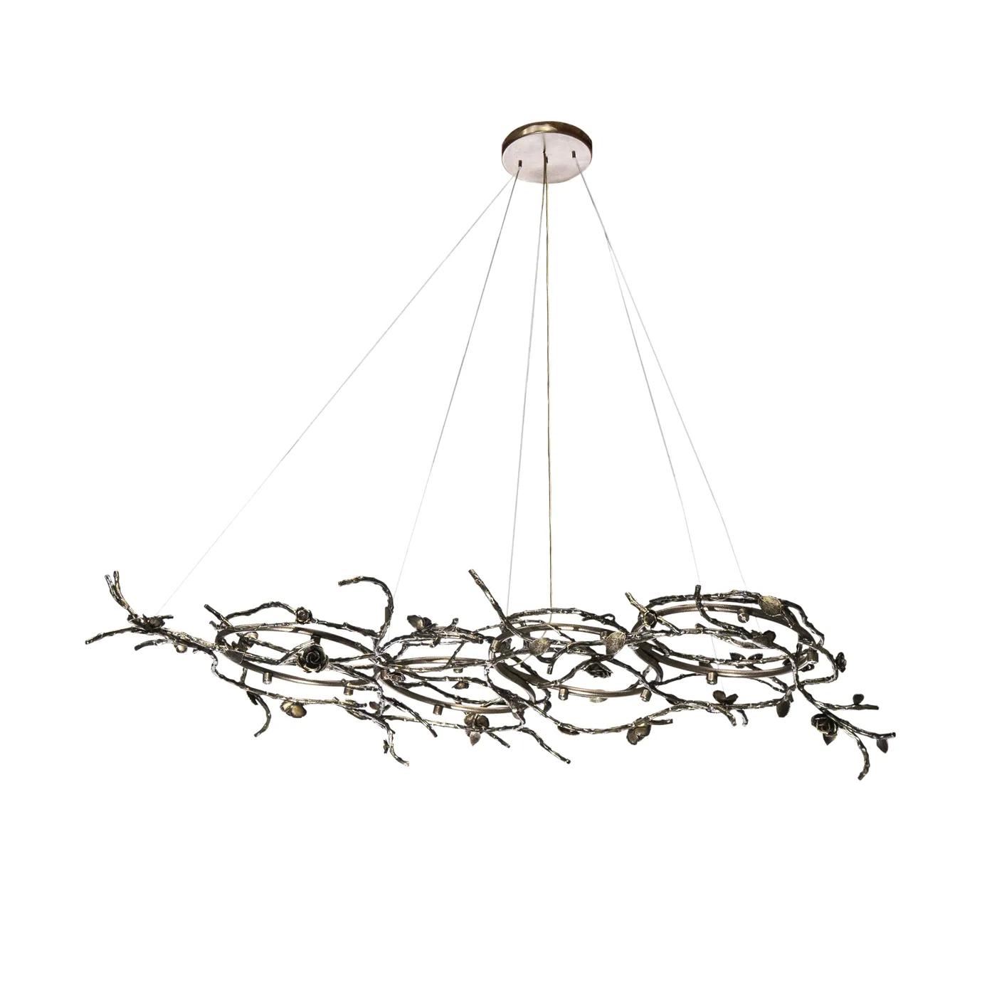 Rose Chandelier in aged brass with sculptural vine-like branches and delicate bud details, suspended by thin cables in a modern interior setting.
