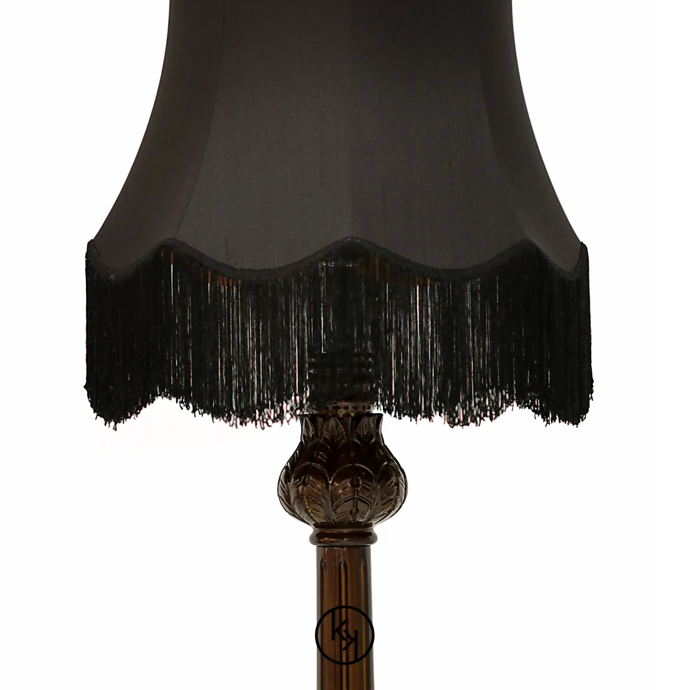 Elegant Lotus Floor Lamp with an ornate sculpted base in brown tones, a decorative vertical stem, and a black lampshade with fringe details.