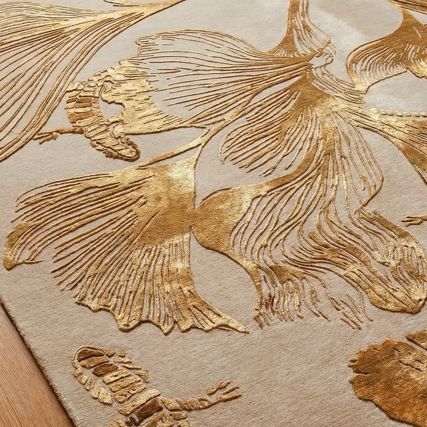 Close-up of KOKET Flora luxury rug showing golden metallic embroidery and hand-tufted botanical details. High-end beige area rug with textured ginkgo leaves and reptile motifs for sophisticated interior design.