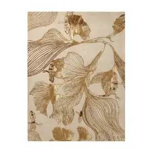Luxury botanical area rug with gold ginkgo leaf pattern and metallic textures. Premium beige and gold hand-tufted rug for high-end interior design projects.