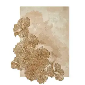 Full view of the KOKET Hibiscus luxury rug featuring an organic arrangement of hand-tufted ginkgo leaves with a metallic bronze finish on a neutral beige background.