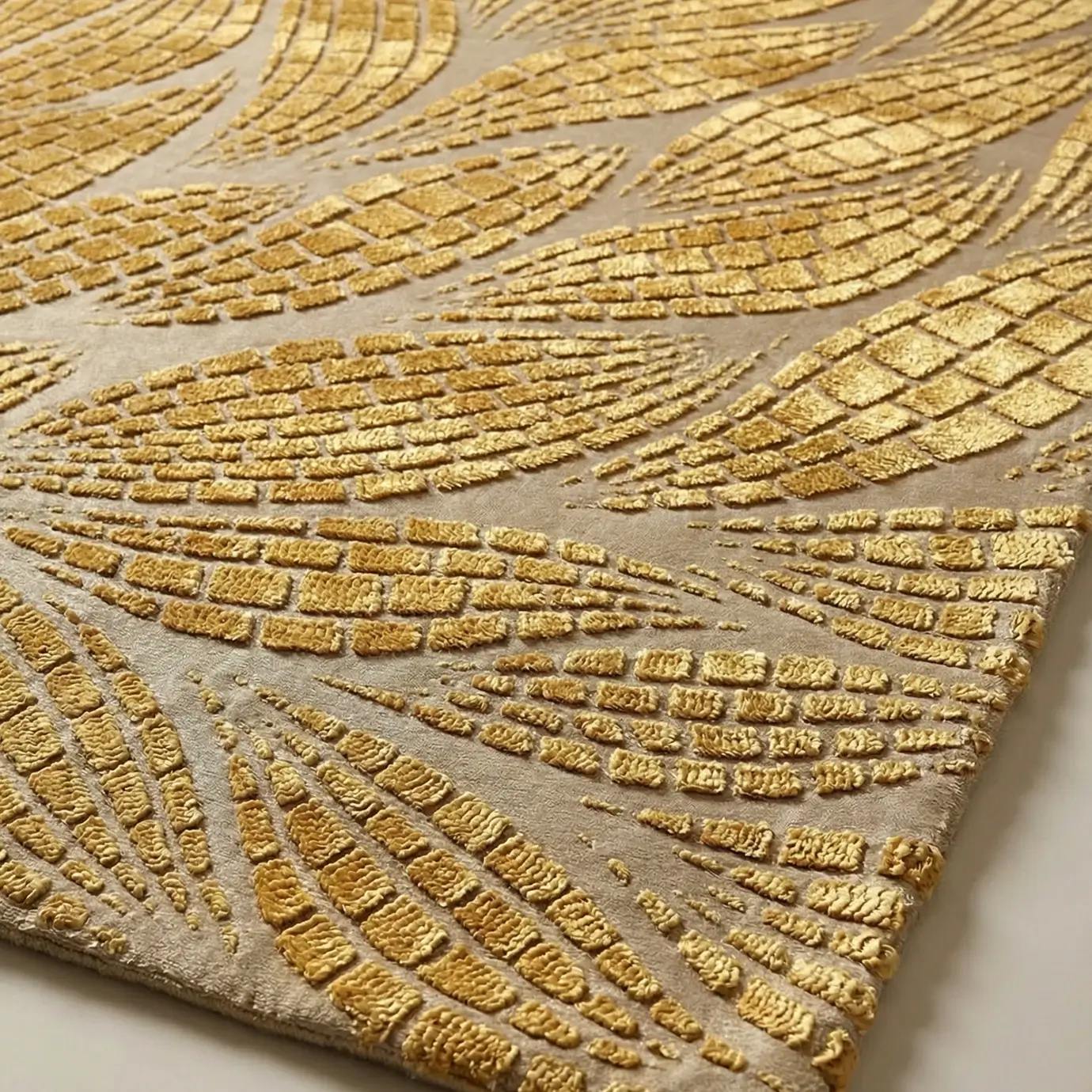 Detailed view of the KOKET Terra Wheat luxury rug, showcasing a stylized mosaic leaf pattern with shimmering gold metallic accents and rich hand-tufted textures.