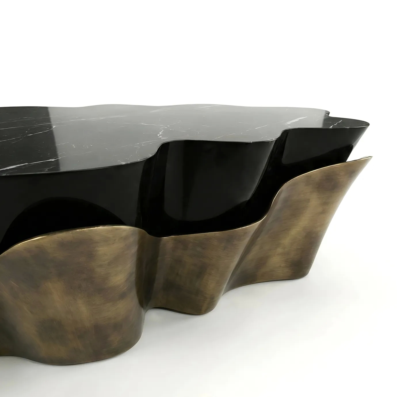 Detail of KOKET’s Yasmine Coffee Table: Aged Gold Powder metal base and Nero Marquina marble top with rippling edge profile.