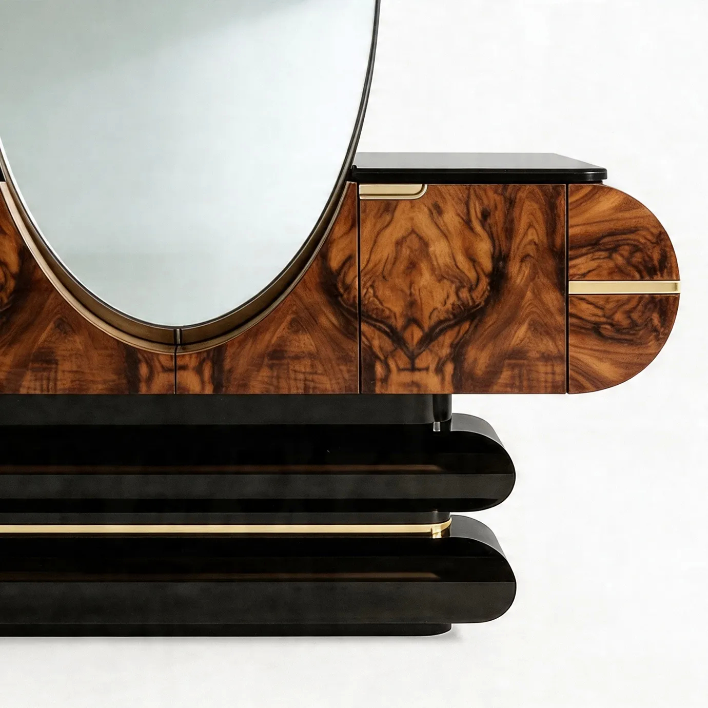 Close-up of KOKET Women Art Deco luxury chest with oval mirror, rich wood veneer, black lacquer base and gold accents.