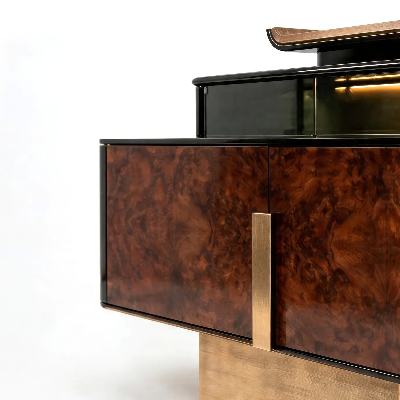 Detail of Delany display cabinet by KOKET with walnut burl doors, brushed brass handle and illuminated smoked glass.