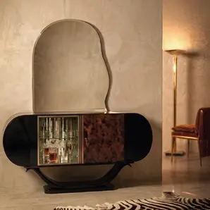Florence bar cabinet by KOKET in a warm interior with a lit floor lamp and zebra-hide rug, barware glowing inside.