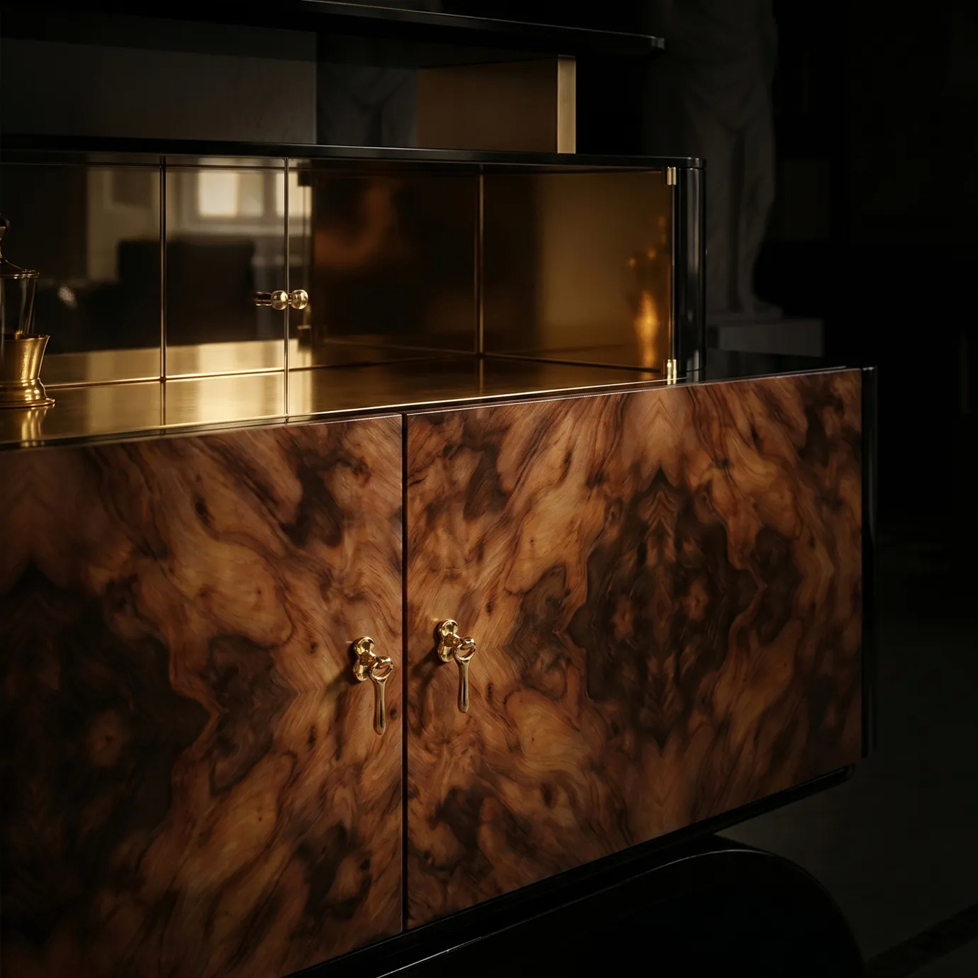 Detail of Odette sideboard by KOKET, brass keys on book-matched walnut burl doors below a smoked glass display tier.