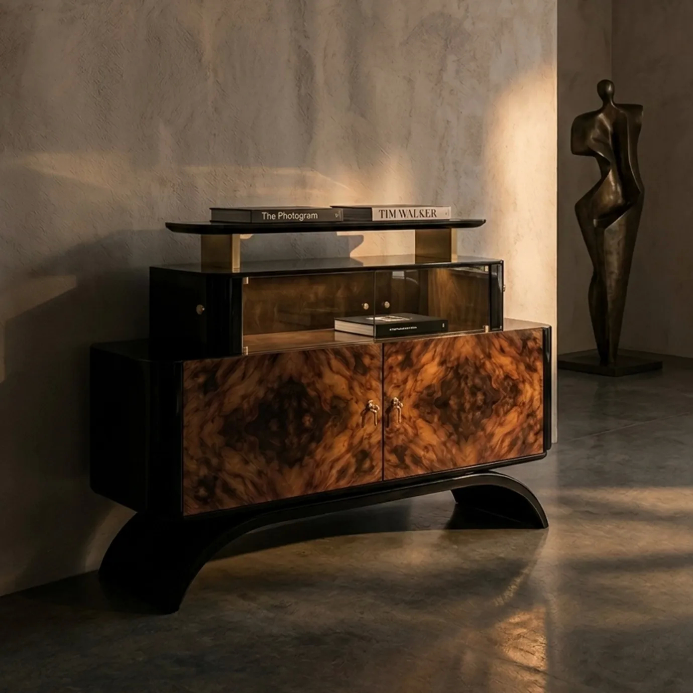 KOKET Women Art Deco luxury chest with rich wood veneer, black lacquer structure, glass display storage and gold accents in an elegant interior.
