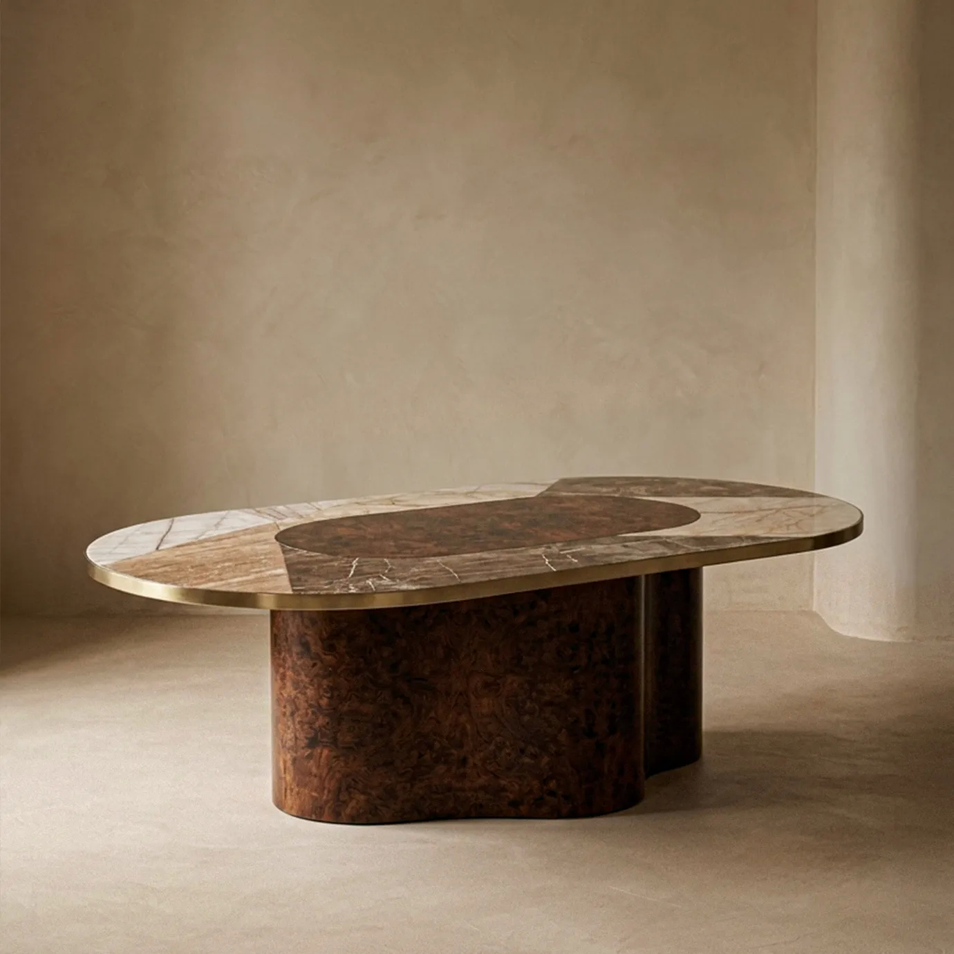 Decodiva dining table by KOKET from the side in a warm interior, stone marquetry top and sculptural walnut root base.