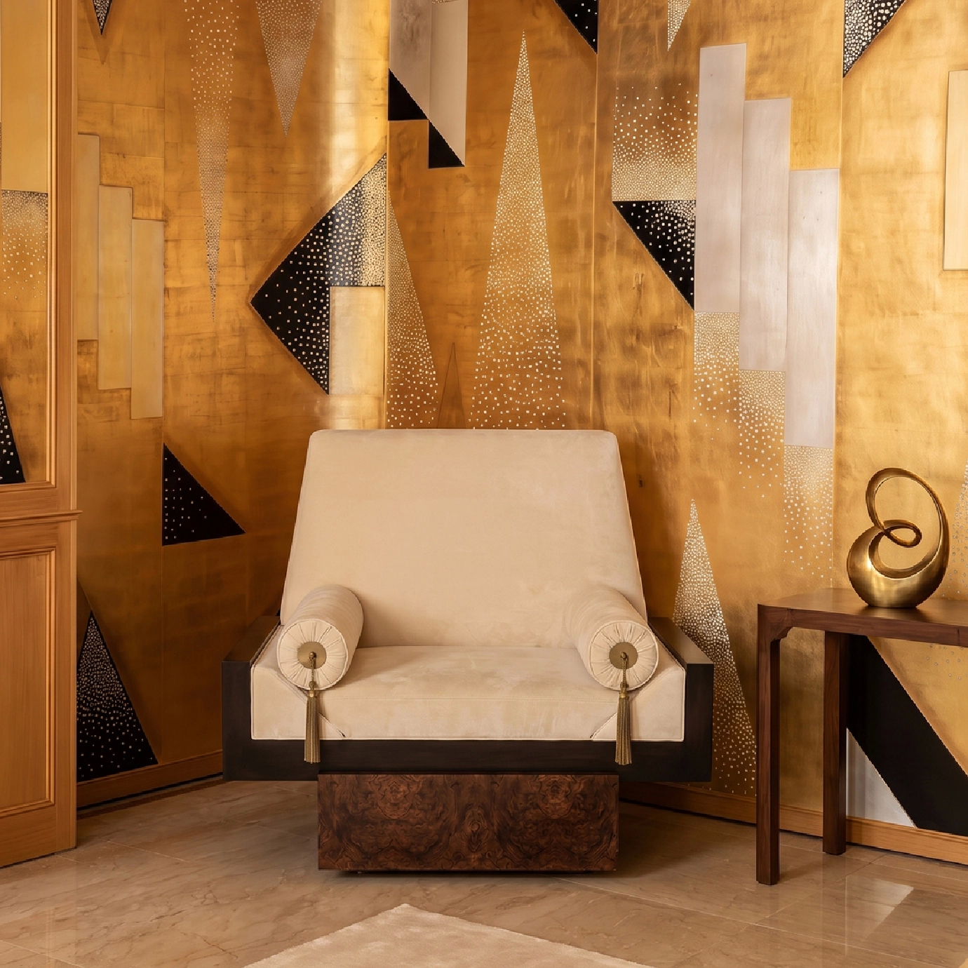 Lola armchair by KOKET in cream velvet with tasseled bolsters on a black lacquer and walnut frame, gold Art Deco wall.