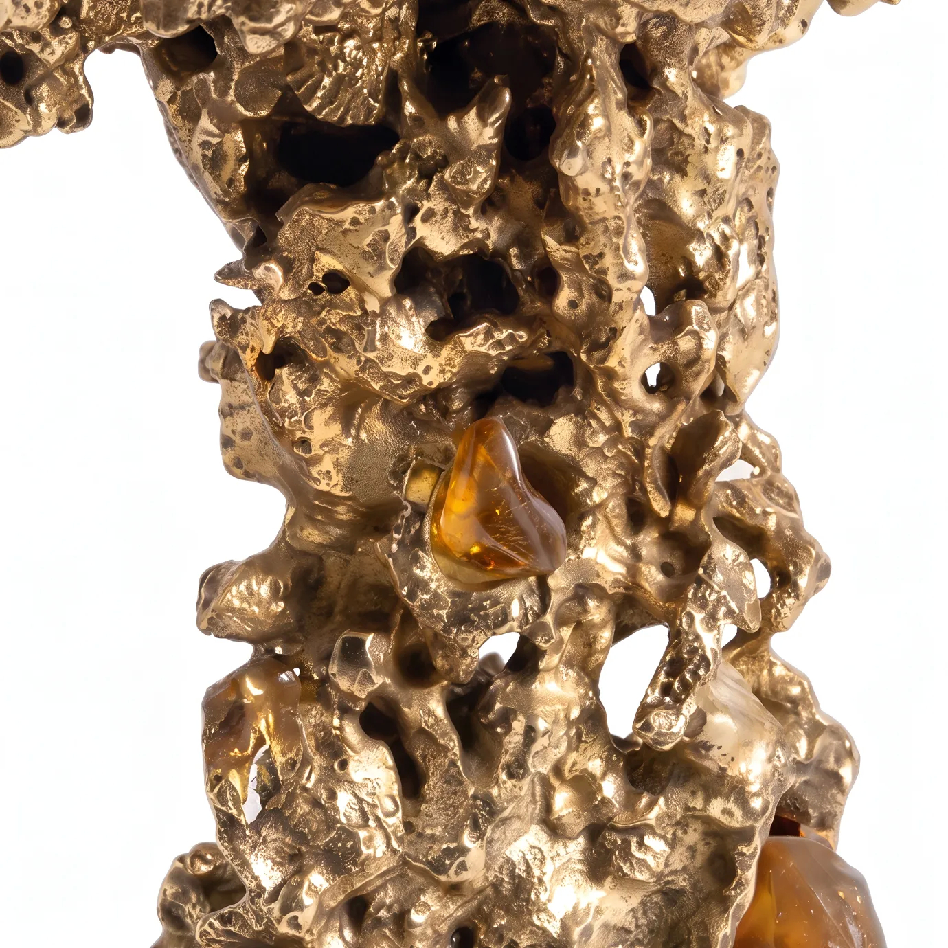 Detail of Empress side table by KOKET, amber rock crystals set into the textured sand-cast brass of the sculptural base.