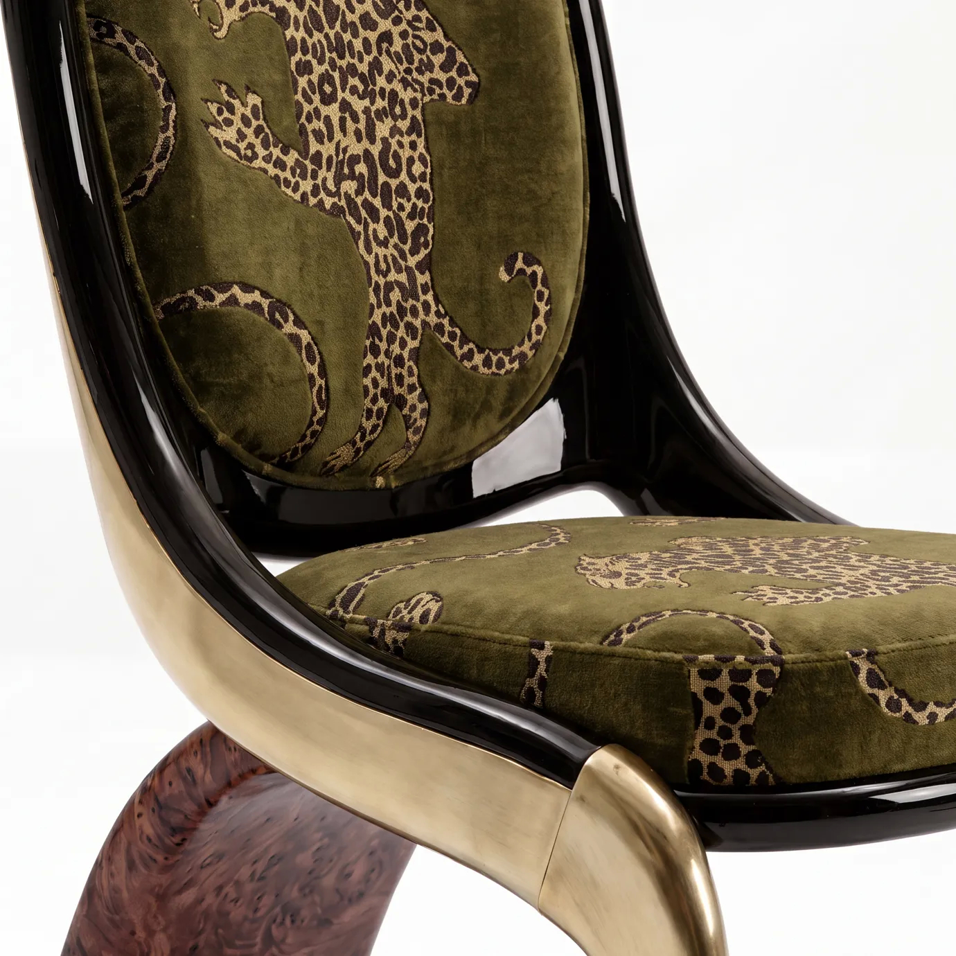 Detail of Gabrielle dining chair by KOKET: leopard print on olive velvet, black lacquer shell, brushed brass and walnut burl.