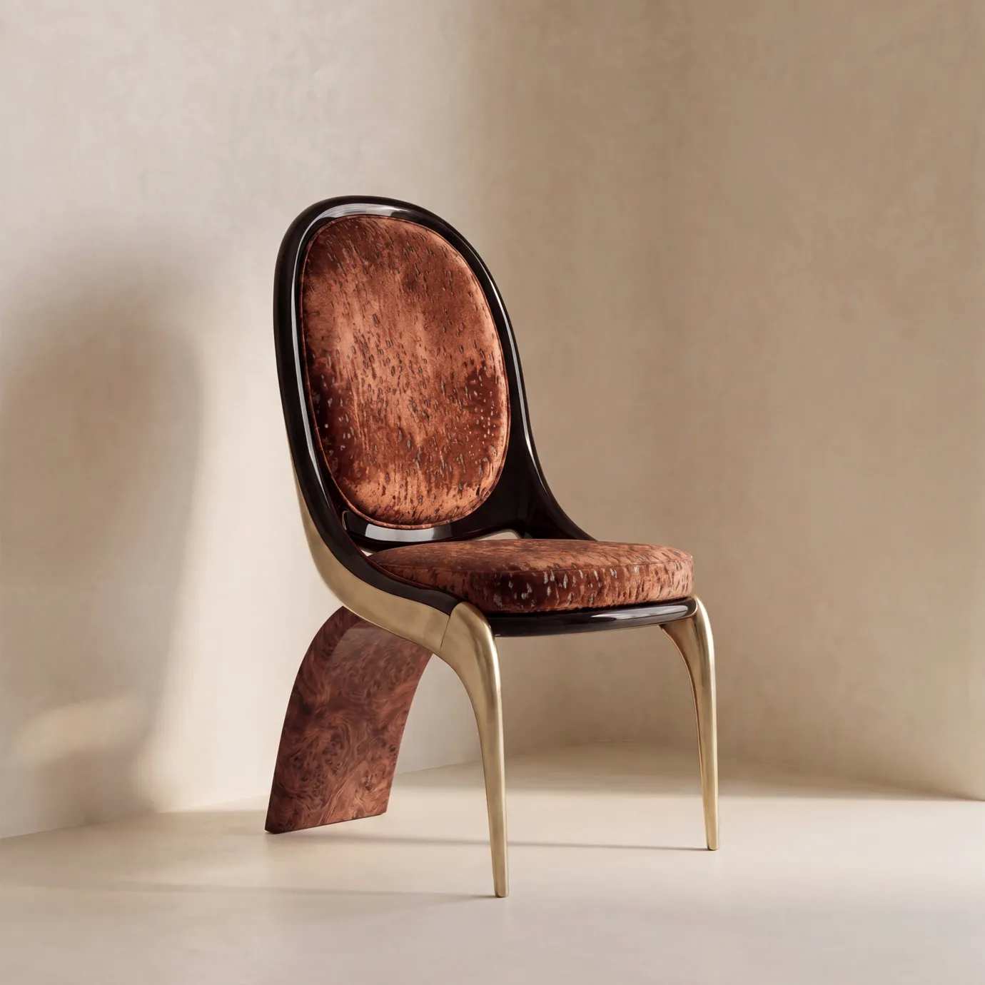Gabrielle dining chair by KOKET in a sunlit corner, mottled rust velvet oval back, brushed brass legs and walnut burl blade.