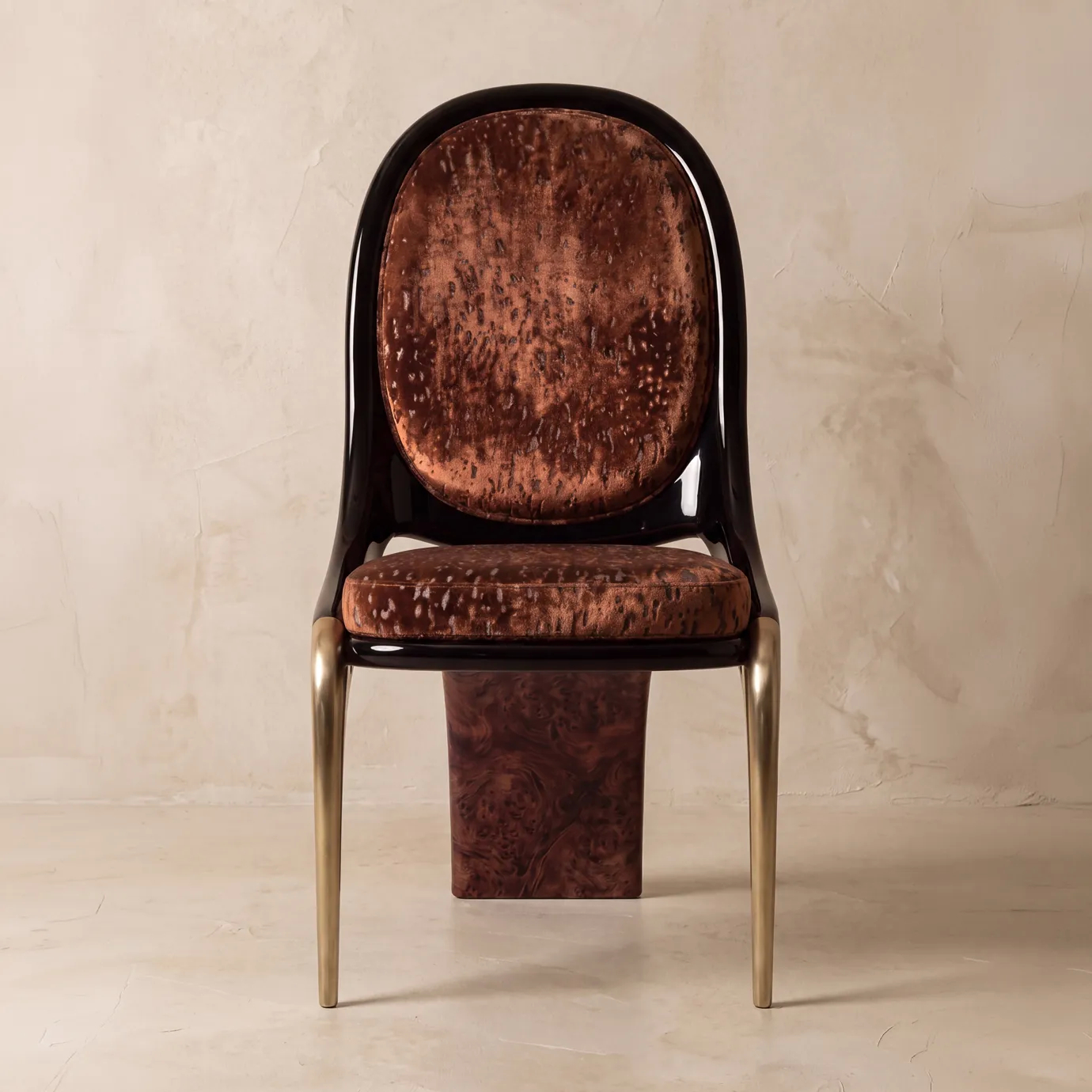 Gabrielle dining chair by KOKET in a plaster interior, mottled rust velvet oval back, brushed brass legs, walnut burl blade.