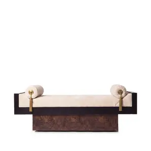 Lola bench by KOKET, front view, cream velvet seat, polished brass medallions, gold tassels, walnut root plinth.