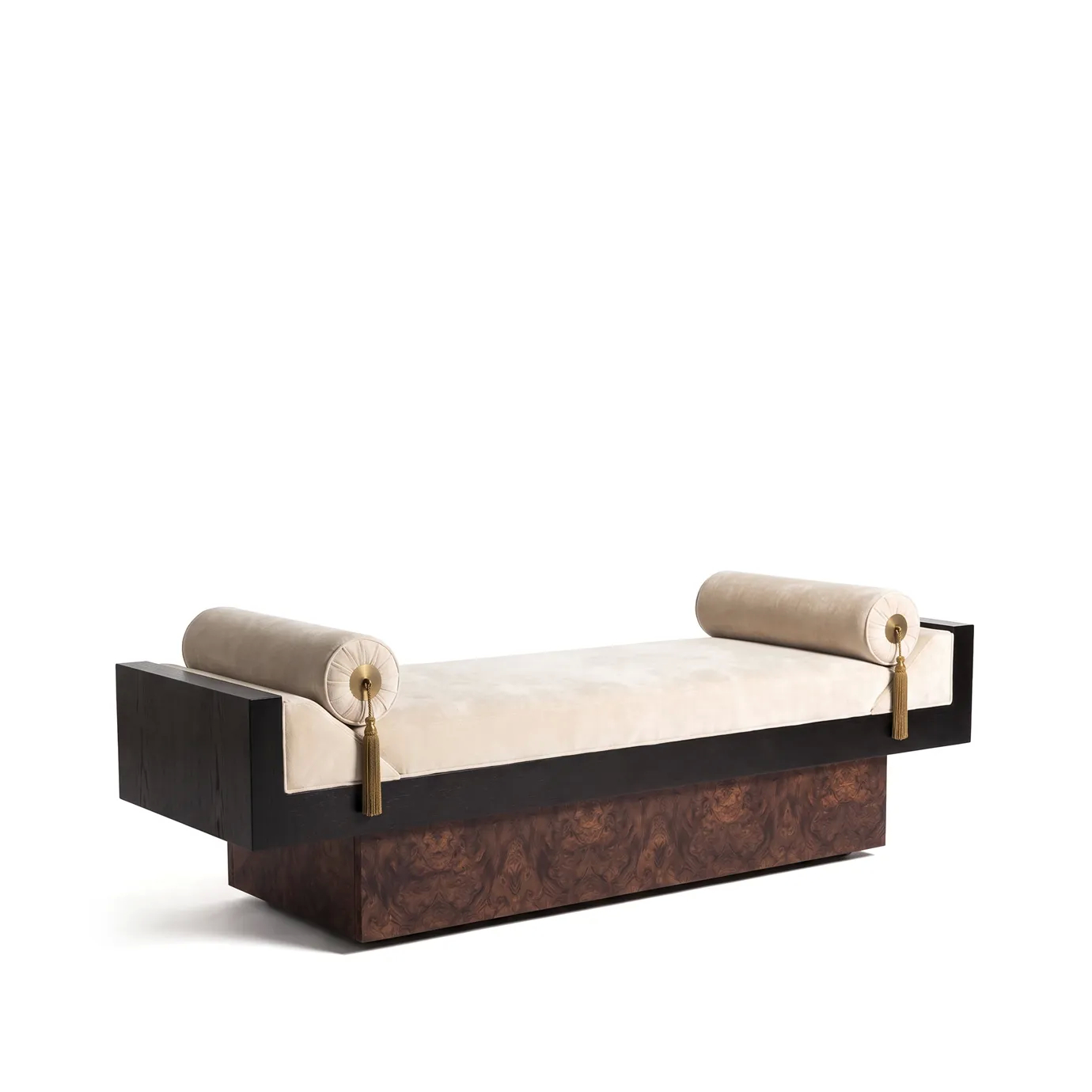 Lola bench by KOKET at an angle, cream velvet seat and bolsters, black stained oak frame on a walnut root plinth.