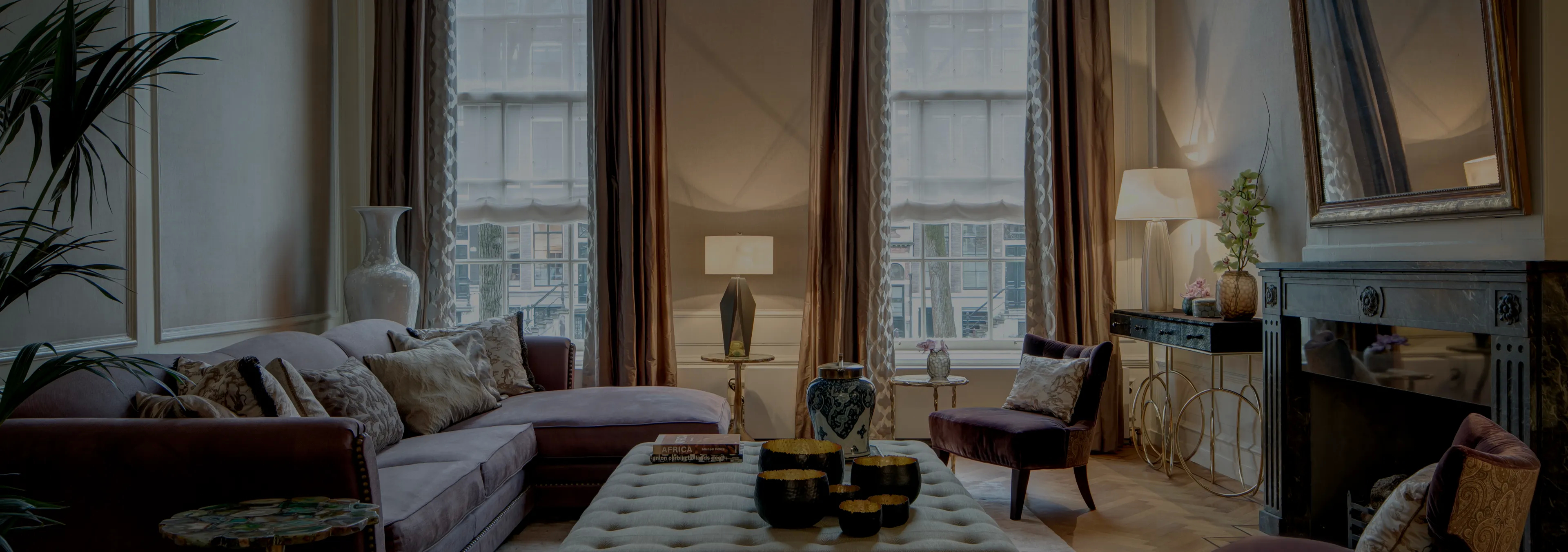 Labor of Love: Two Naomi chairs with golden velvet upholstery and black legs, with a decorative glass vase.
