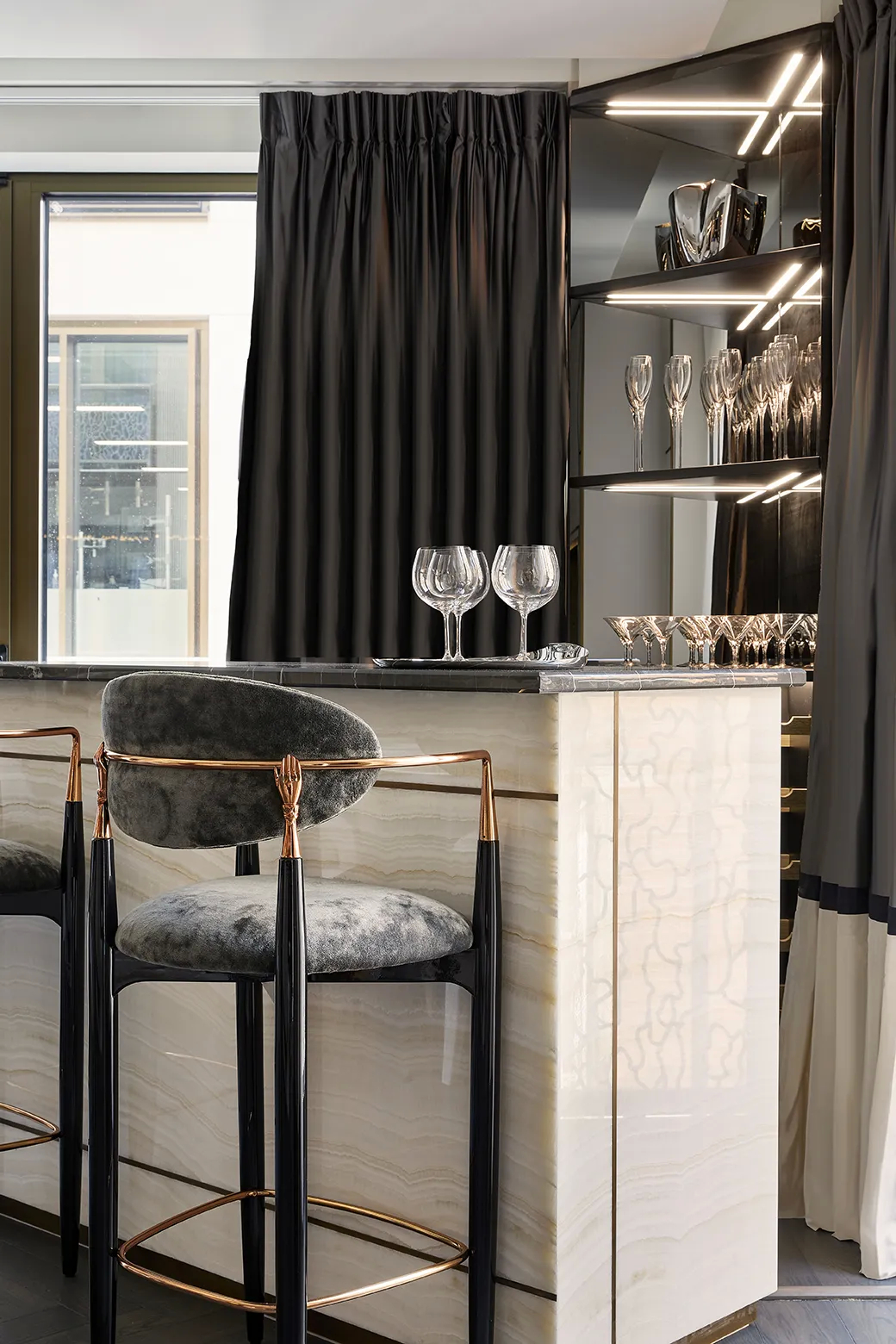 A Nahéma bar stool with a distinctive design in a luxurious bar area, part of Koket's Private Apartment project.