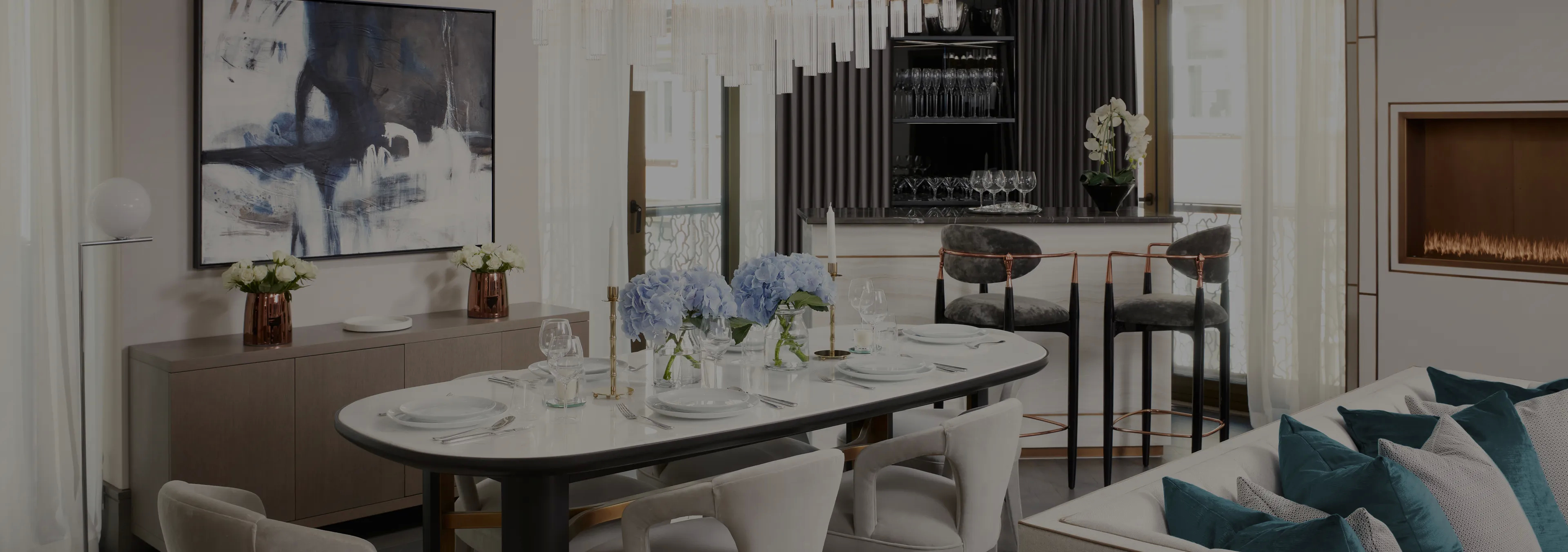 Labor of Love: Two Naomi chairs with golden velvet upholstery and black legs, with a decorative glass vase.