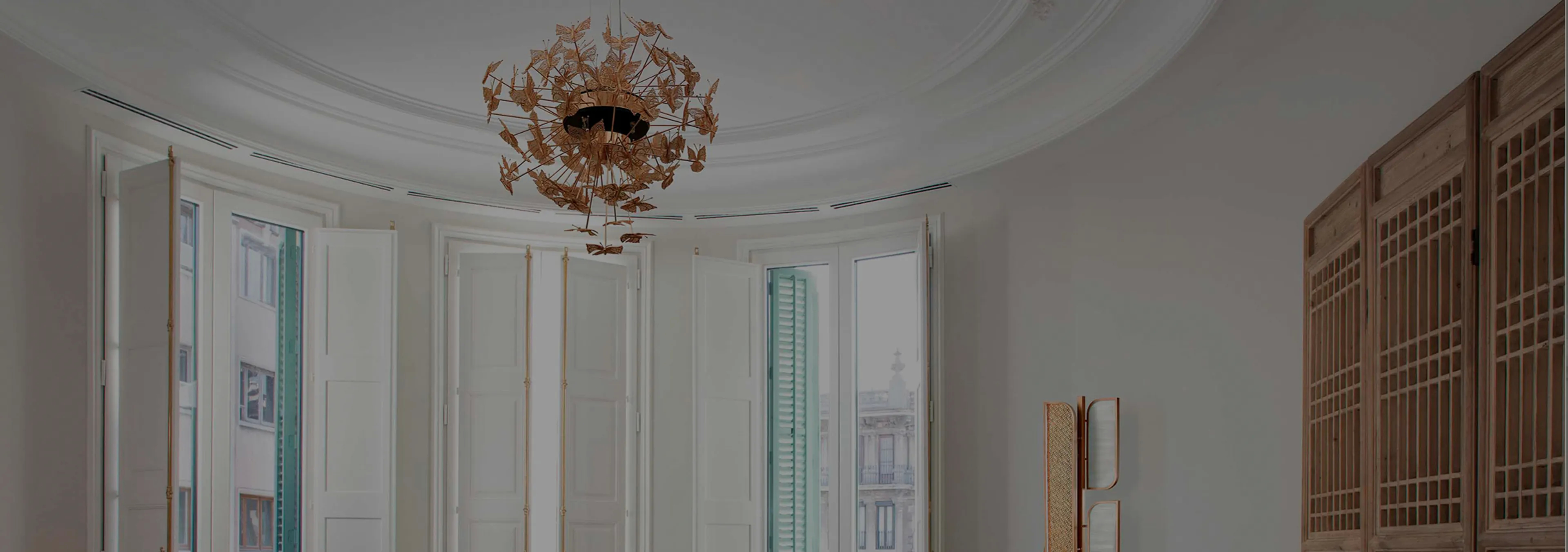 Labor of Love: Two Naomi chairs with golden velvet upholstery and black legs, with a decorative glass vase.