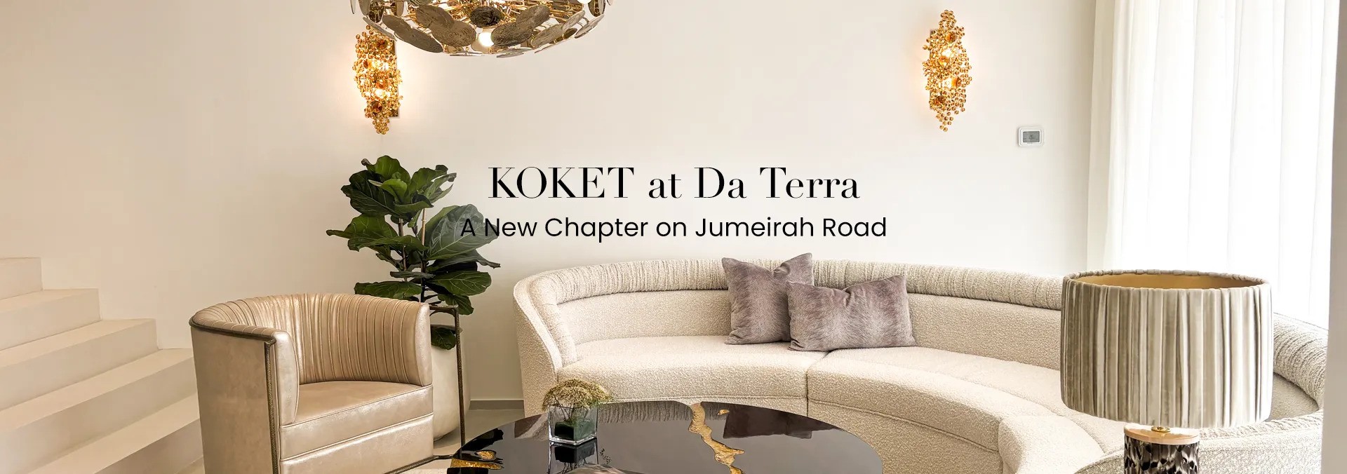 A luxurious living room featuring a curved sofa, two Eternity Amber Glass Sconces, and a beige Desire Chair. The text 'KOKET at Da Terra, A New Chapter on Jumeirah Road' is overlaid on the image.