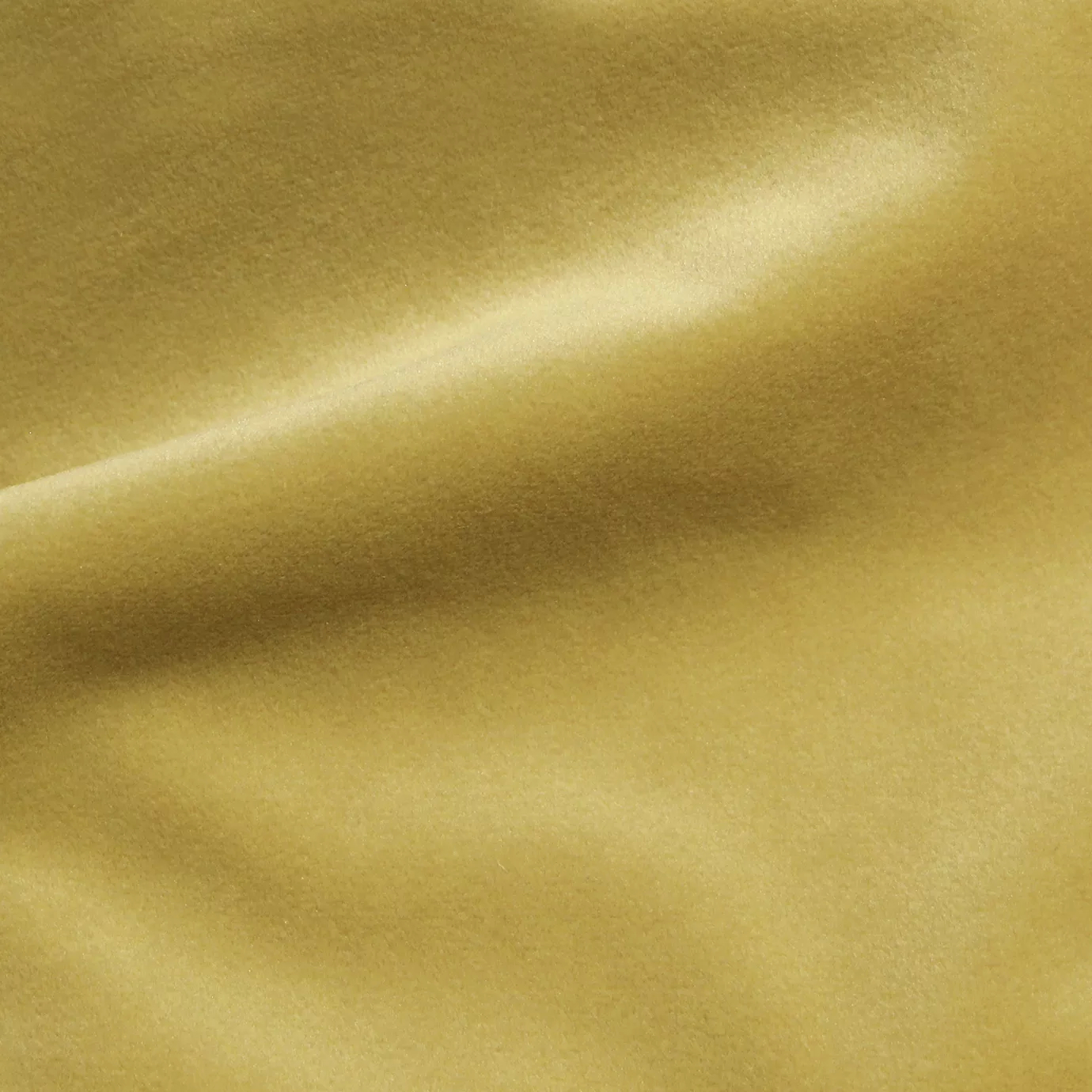 Elegant close-up of a Cozy Velvet Chamomile fabric swatch in a soft and warm chamomile tone, showcasing its velvety texture and the gentle folds that create subtle highlights.
