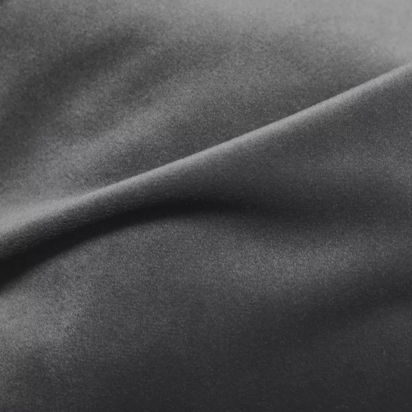 Elegant close-up of a Cozy Velvet Charcoal Gray fabric swatch in a sophisticated and deep charcoal gray tone, showcasing its velvety texture and the gentle folds that give it a feeling of understated elegance.