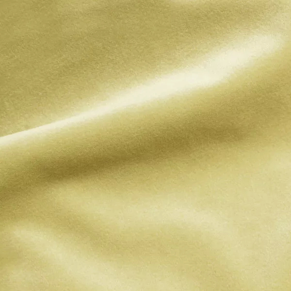 Elegant close-up of a Cozy Velvet Vanilla fabric swatch in a soft vanilla tone, showcasing its smooth and slightly lustrous texture with gentle folds that catch the light.