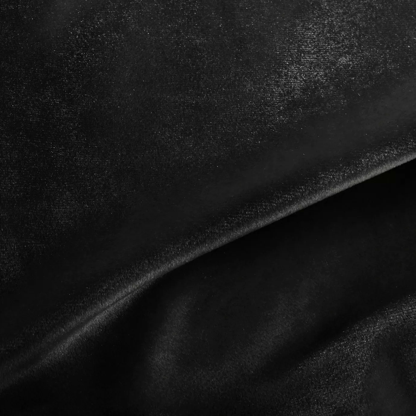 Elegant close-up of a Silky Velvet 406 fabric swatch in a deep and luminous black tone, showcasing its smooth texture and the delicate folds that highlight its intense elegance.