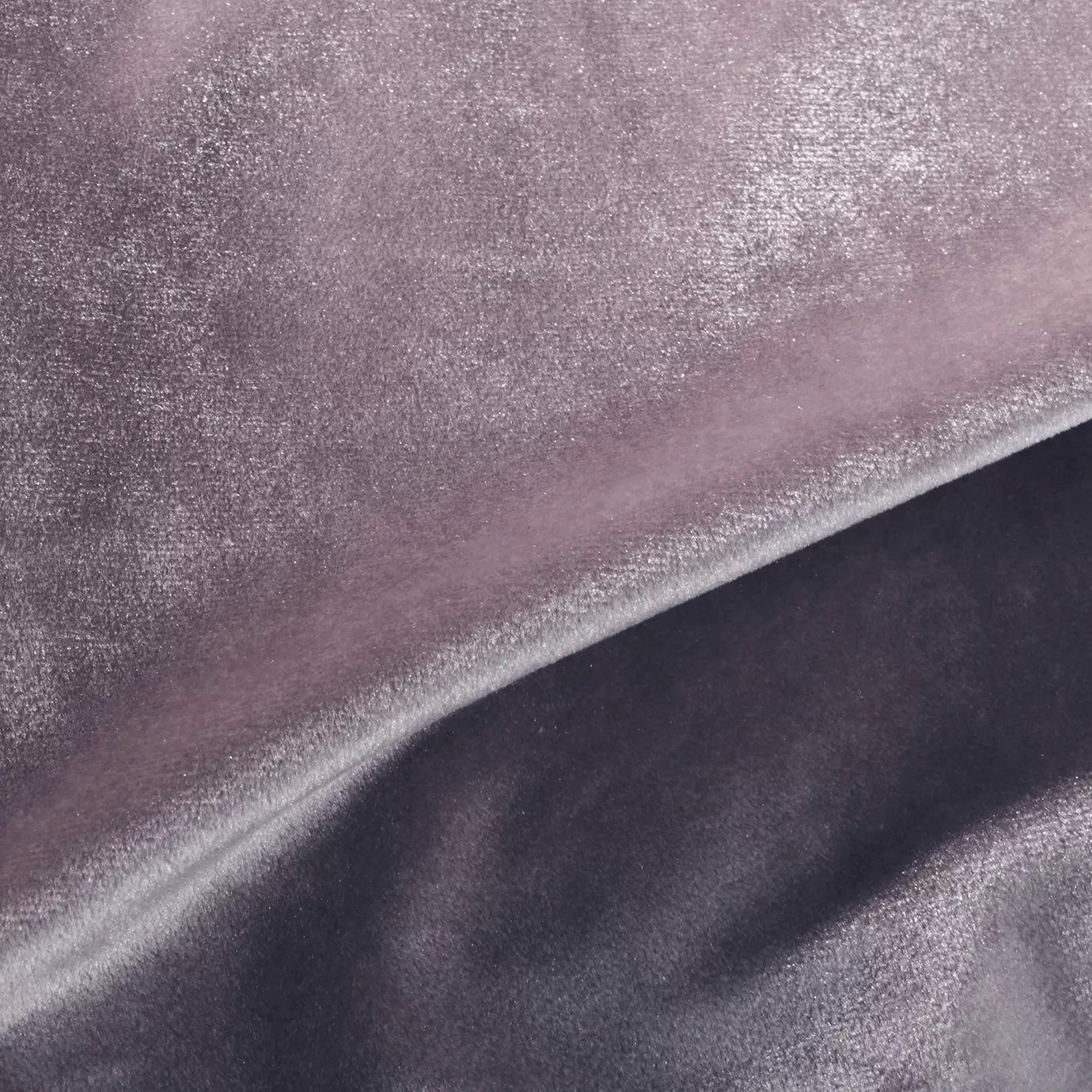 Elegant close-up of a Silky Velvet 418 fabric swatch in a luminous and soft rose gray tone, showcasing its smooth texture and the delicate folds that highlight its sophisticated and silky sheen.