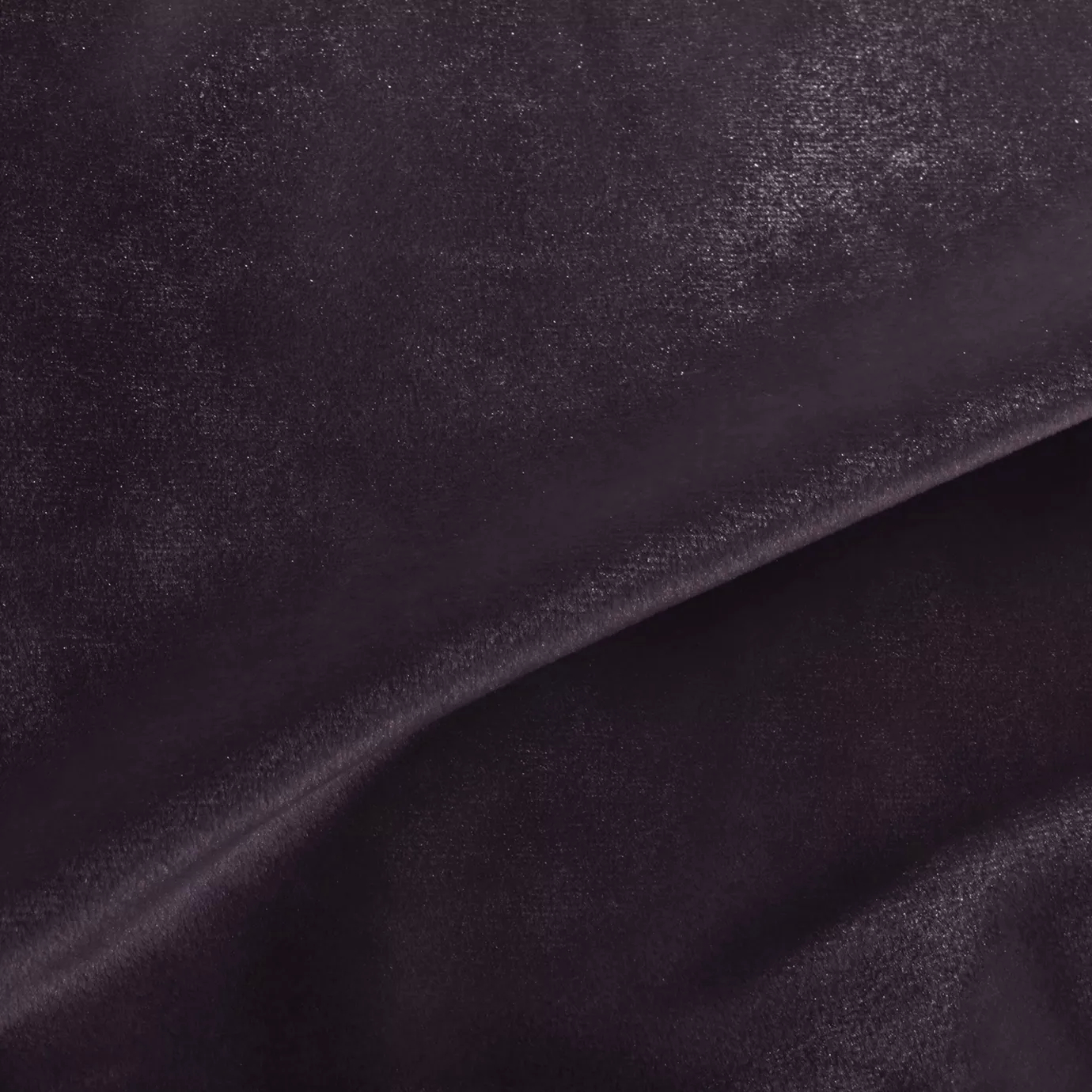 Elegant close-up of a Silky Velvet 438 fabric swatch in a luminous and rich plum purple tone, showcasing its smooth texture and the delicate folds that highlight its deep and silky sheen.