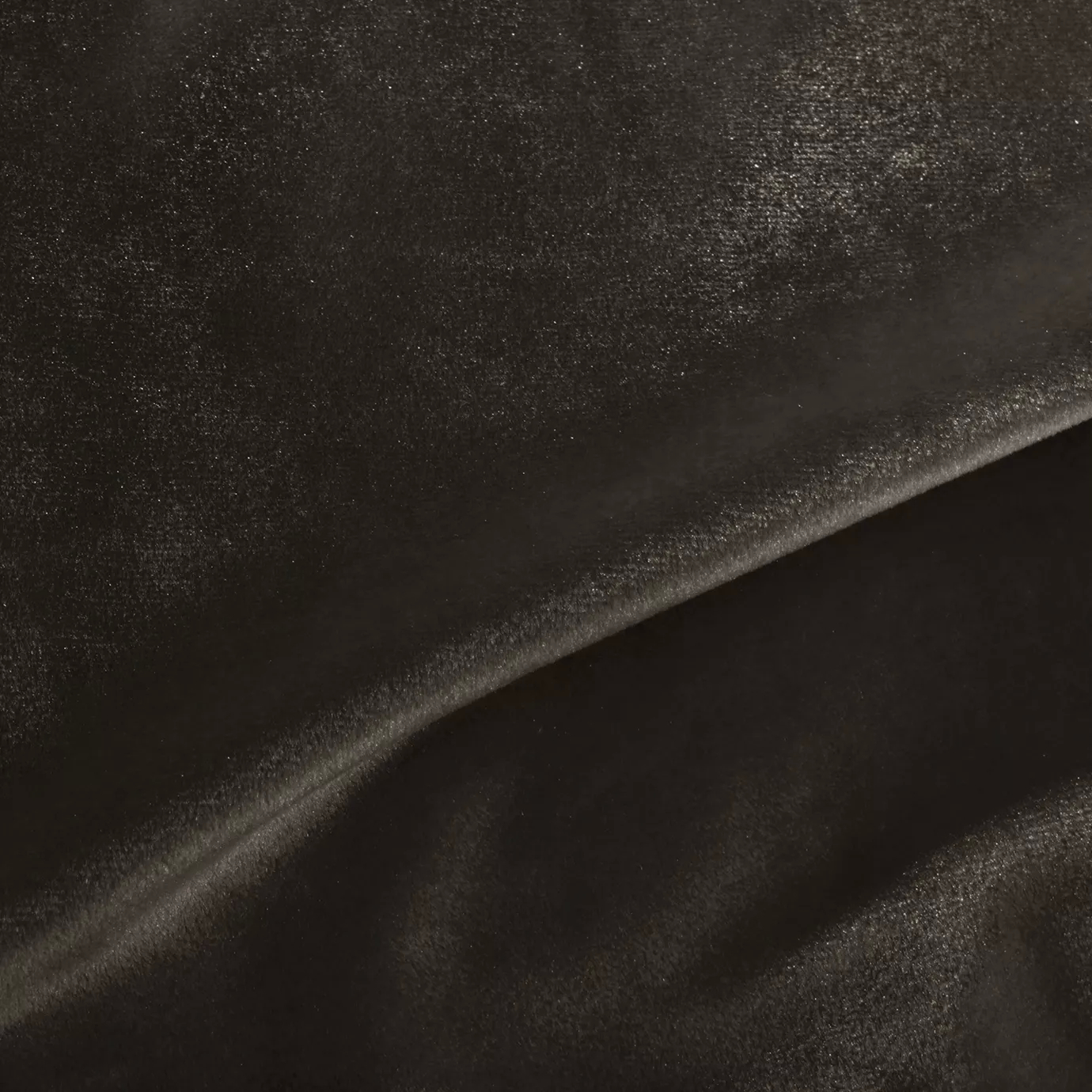 Elegant close-up of a Silky Velvet 457 fabric swatch in a luminous and soft medium brown tone, showcasing its smooth texture and the delicate folds that highlight its natural elegance.