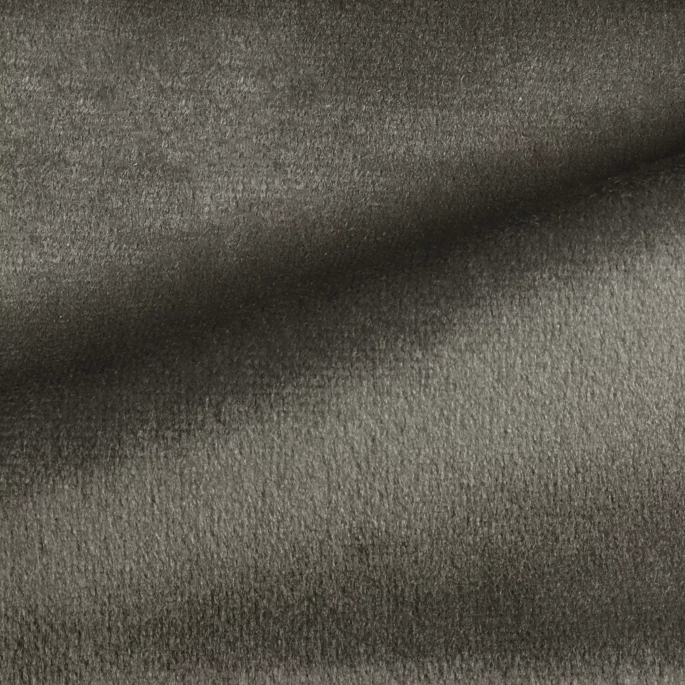 Elegant close-up of a Radiance Velvet Charcoal Gray fabric swatch in a sophisticated and deep charcoal gray tone, showcasing its velvety texture and a subtle sheen that gives it a feeling of understated and modern elegance.