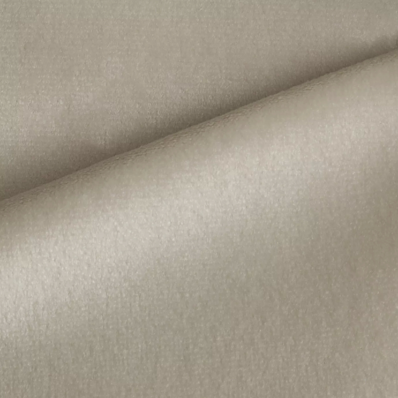 Elegant close-up of a Radiance Velvet Cream fabric swatch in a soft and luminous cream tone, showcasing its velvety texture and a subtle sheen that gives it a feeling of comfort and delicate elegance.